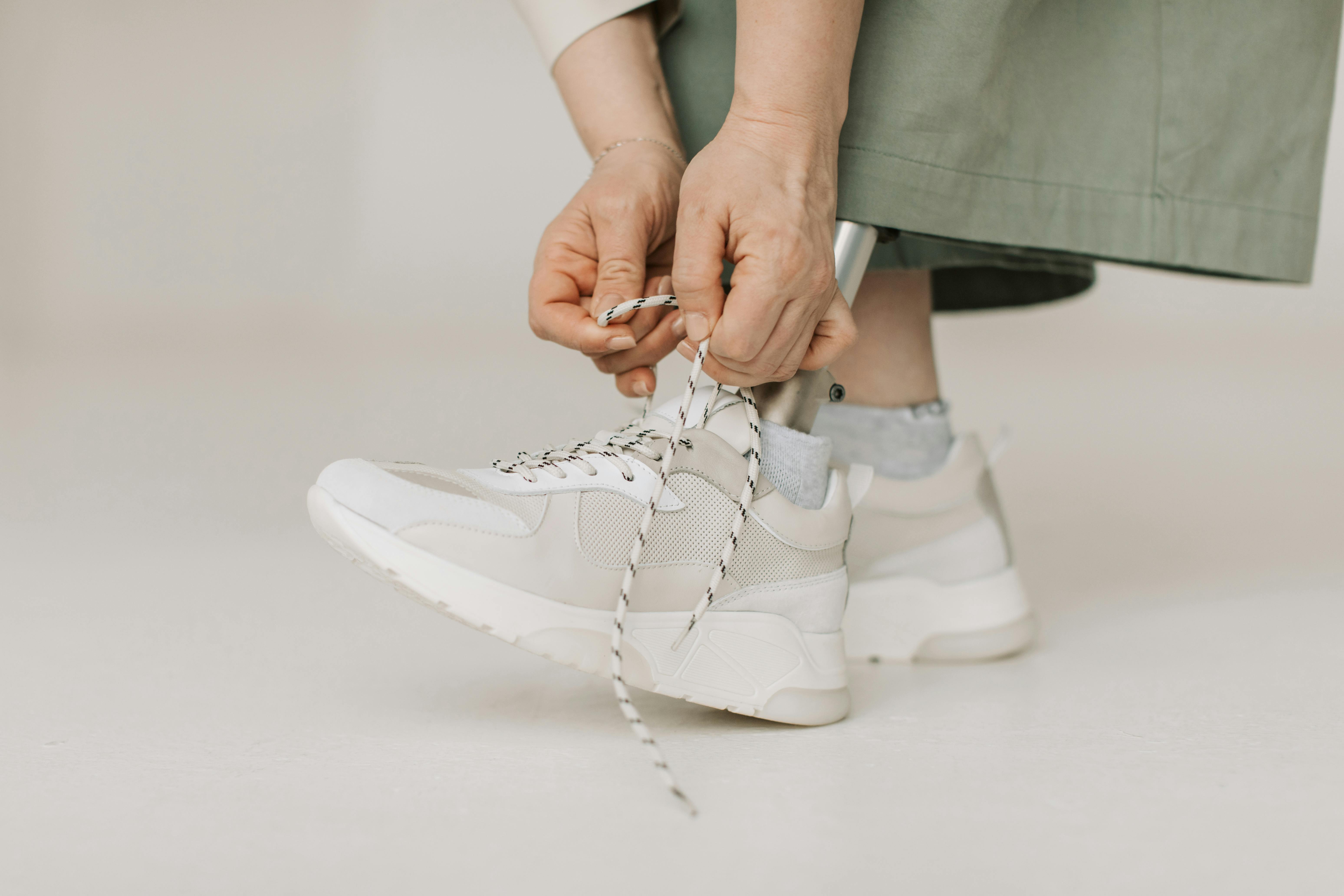 A woman putting on her shoes | Source: Pexels