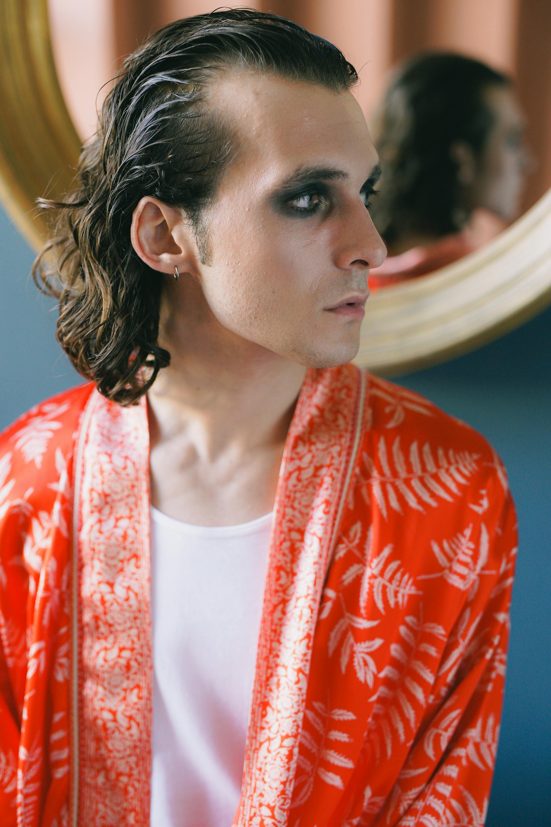 A man with makeup looking sideways | Source: Pexels