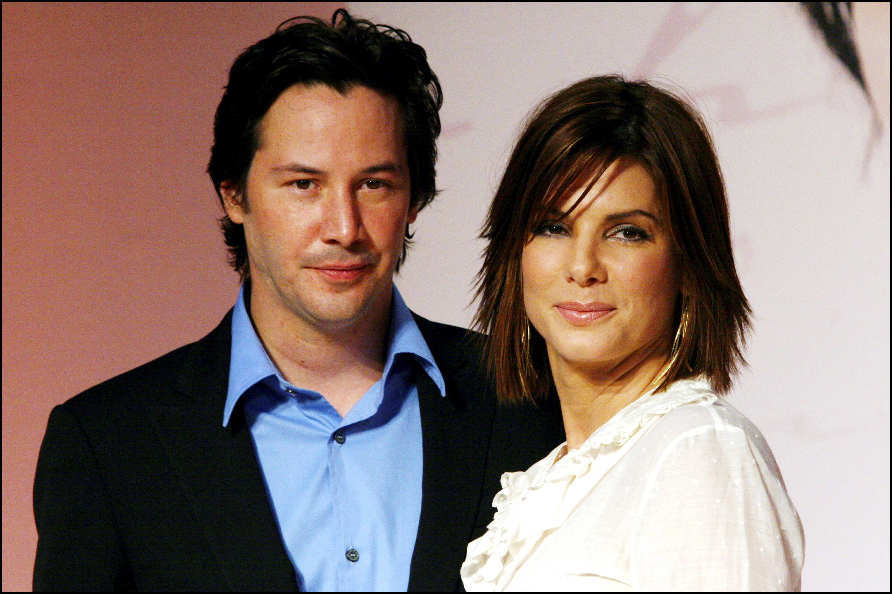 Keanu Reeves poses with co-actor Sandra Bullock pose during a press conference promoting the film, "The Lake House," on September 5, 2006 | Source: Getty Images