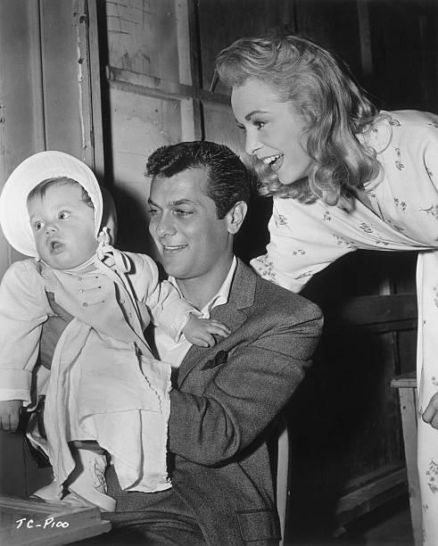  American actors Tony Curtis and Janet Leigh smile at their daughter, Kelly Lee | Source: Getty Images