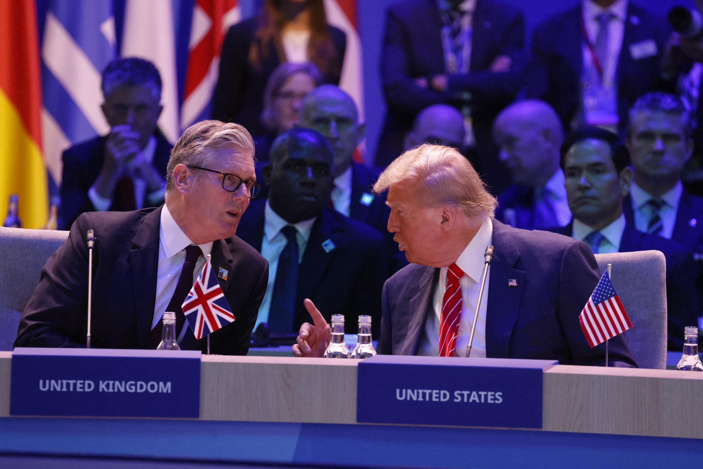 At the plenary meeting, Trump is captured in an animated exchange with Britain’s Prime Minister Keir Starmer. With his finger raised mid-gesture, he appears to be making a pointed remark, while Starmer listens attentively.