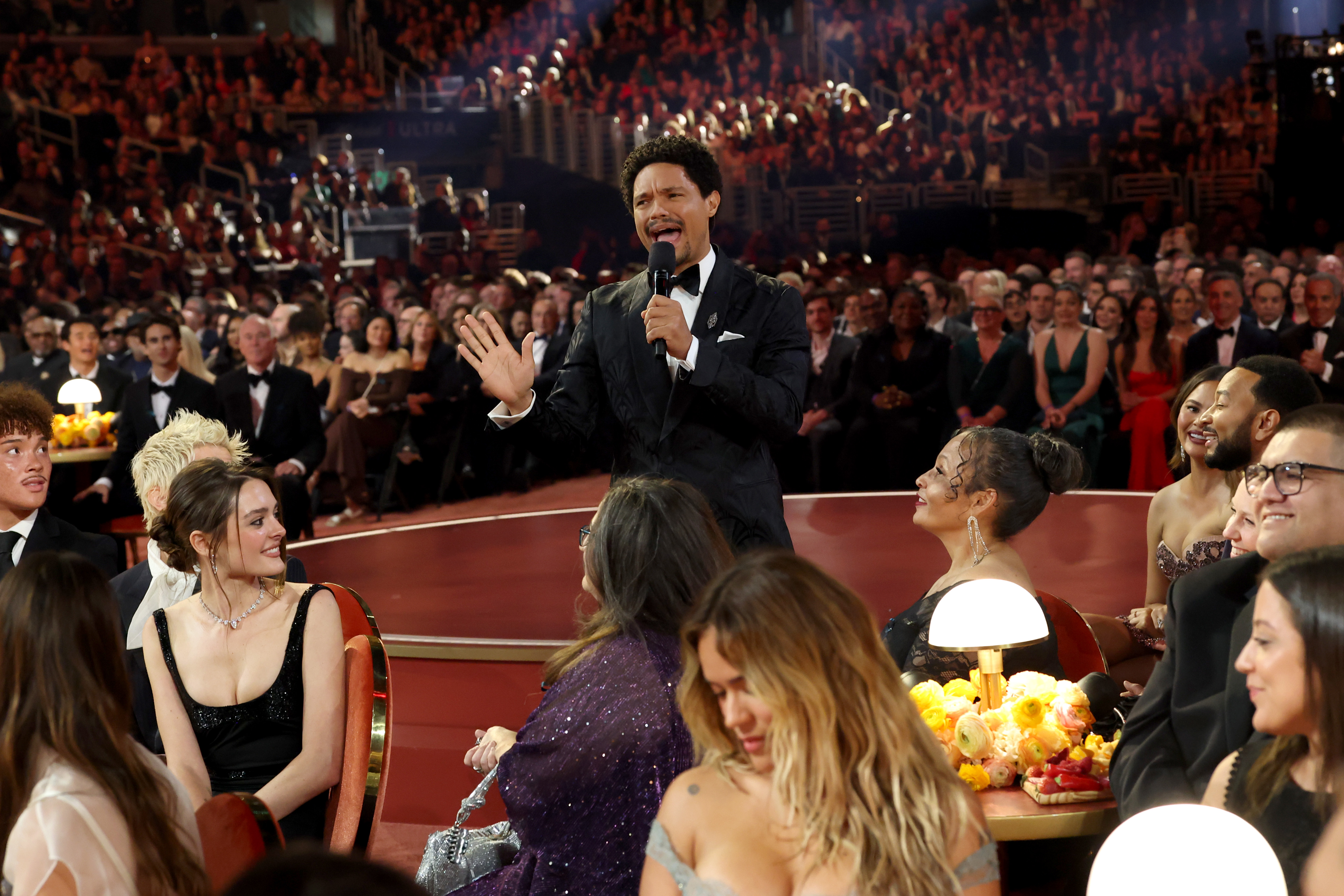 Trevor Noah speaking and engaging with the crowd at the 68th Grammy Awards in Los Angeles, California on February 1, 2026. | Source: Getty Images