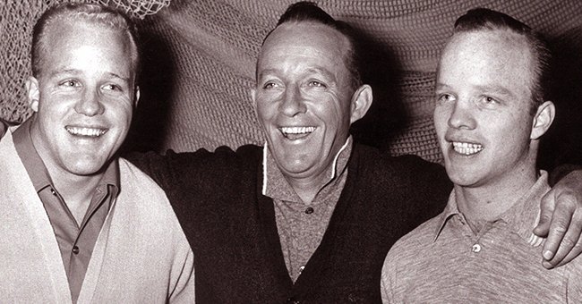 Bing Crosby smiles with his twin sons, Philip and Dennis, on the set of director Frank Tashlin's film, "Say One For Me" in January 1965. | Photo: Getty Images