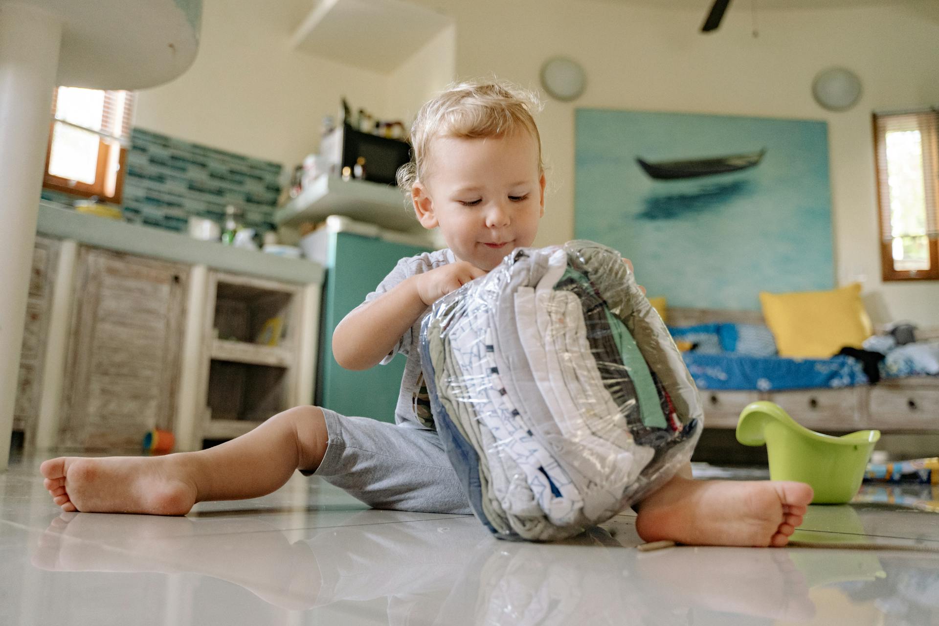 A child playing with clothes in a plastic bag | Source: Pexels