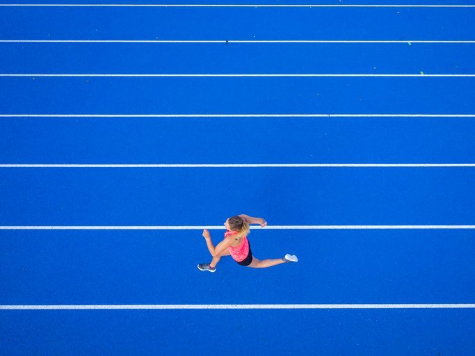 A female runner on tartan track | Photo: Getty Images