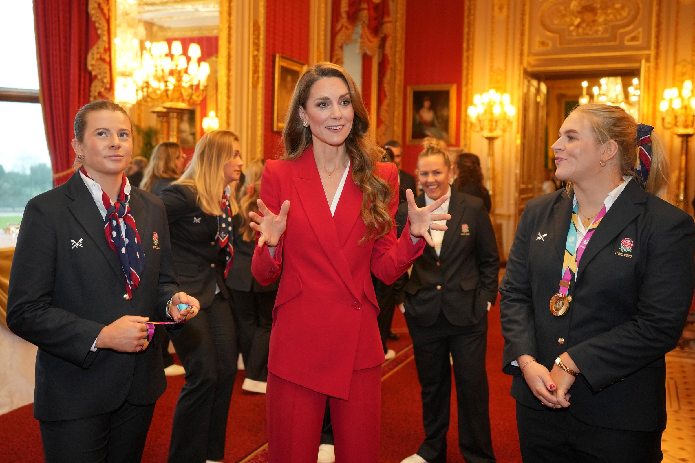 In the grandeur of a gilded state room at Windsor Castle, Princess Catherine animatedly spoke with members of the World Cup-winning Red Roses, drawing laughter and smiles as she joked about her children's playful tackles. Her bright red suit mirrored the team’s colours, as she celebrated their historic victory in September 2025 with a blend of royal poise and genuine enthusiasm.