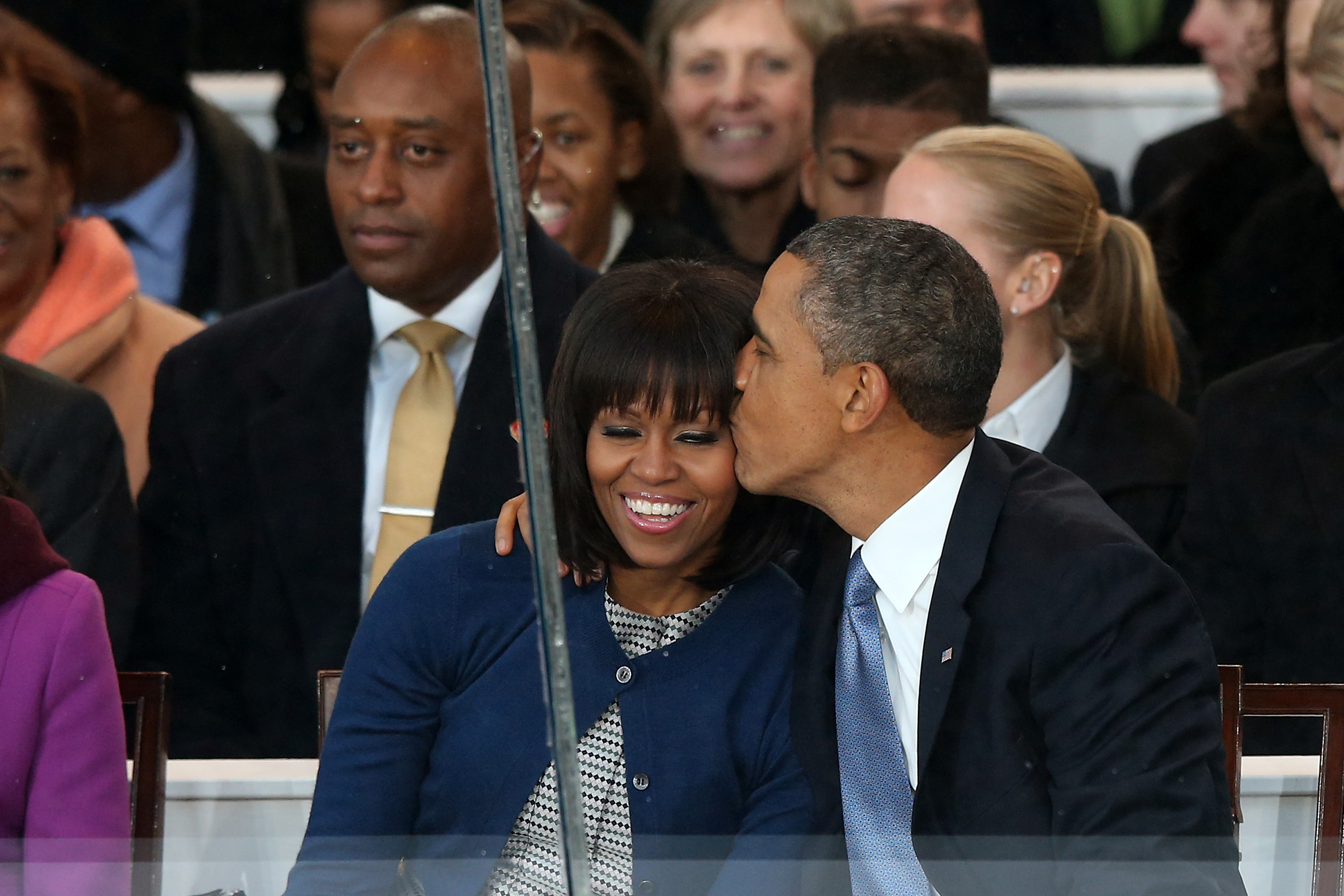 Barack Obama kissing Michelle Obama on the reviewing stand during the presidential inaugural parade on January 21, 2013, in Washington, D.C. | Source: Getty Images