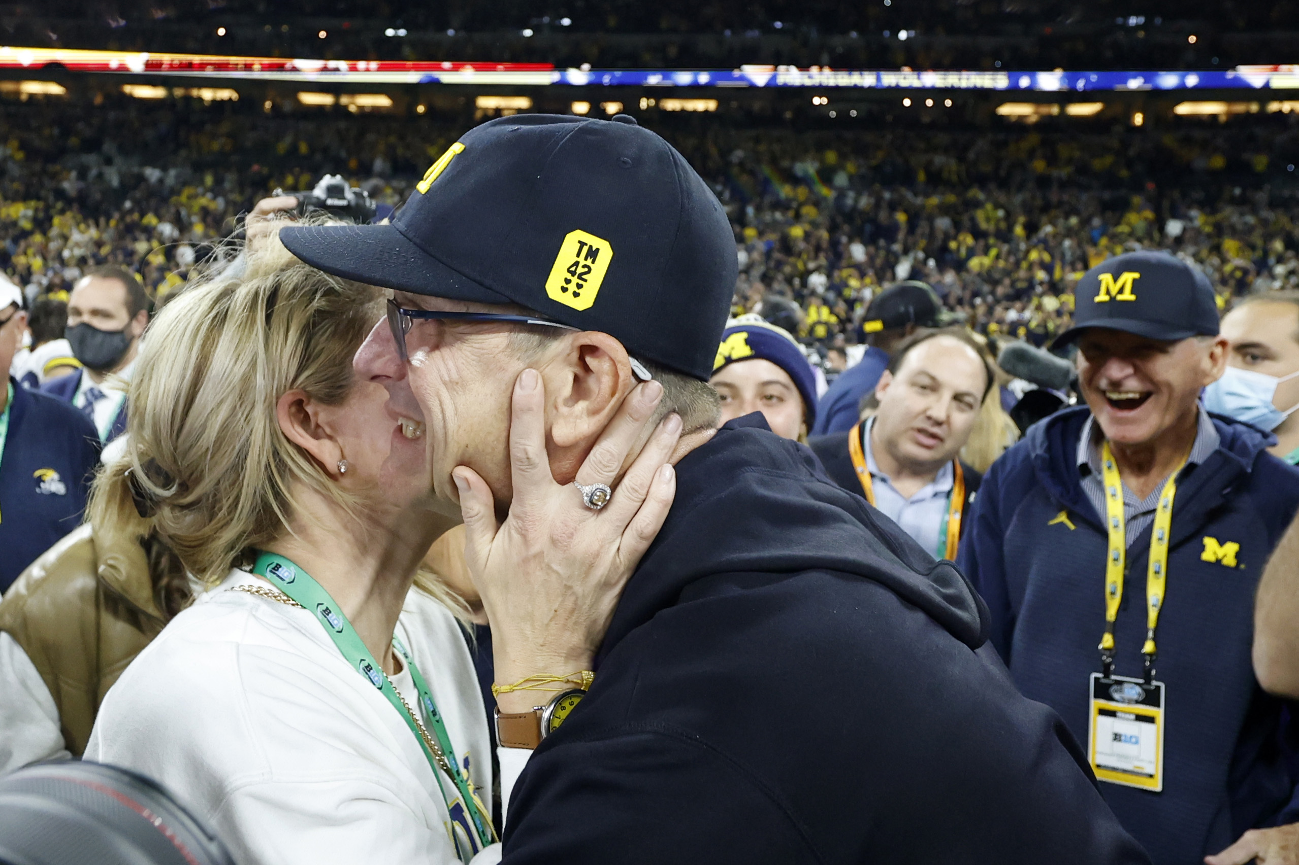 Jim Harbaugh is congratulated by his wife Sarah Harbaugh after defeating the Iowa Hawkeyes in the Big Ten Football Championship Game on December 4, 2021, in Indianapolis, Indiana | Source: Getty Images