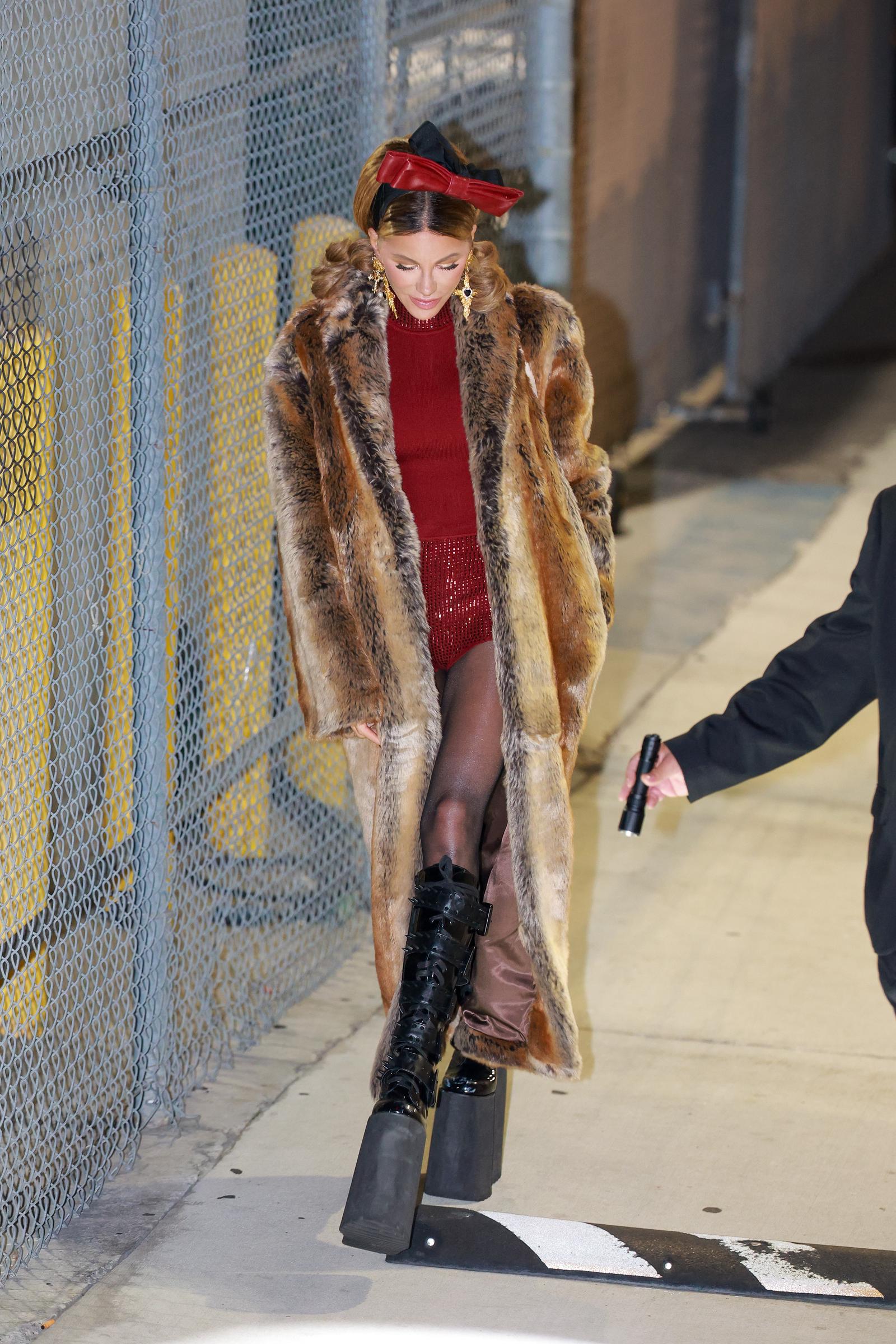 In another shot from the same event, Kate Beckinsale's shoes can be admired. They were extremely tall, chunky black platform boots featuring both laces and buckles, providing an exaggerated, imposing silhouette.