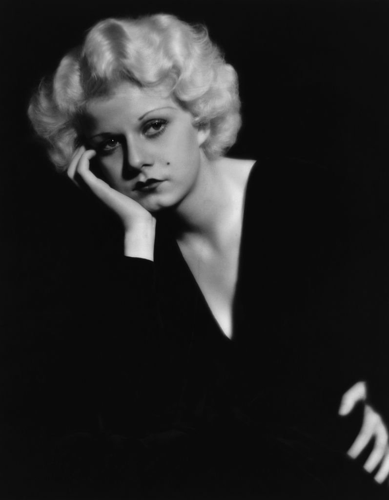 Portrait of Jean Harlow in a pensive pose, wearing a black v-necked dress on January 01, 1930 | Photo: Getty Images