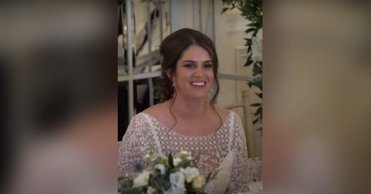 Ian Young's bride Katie blushing while he's giving the speech | Source: YouTube / Daily Record