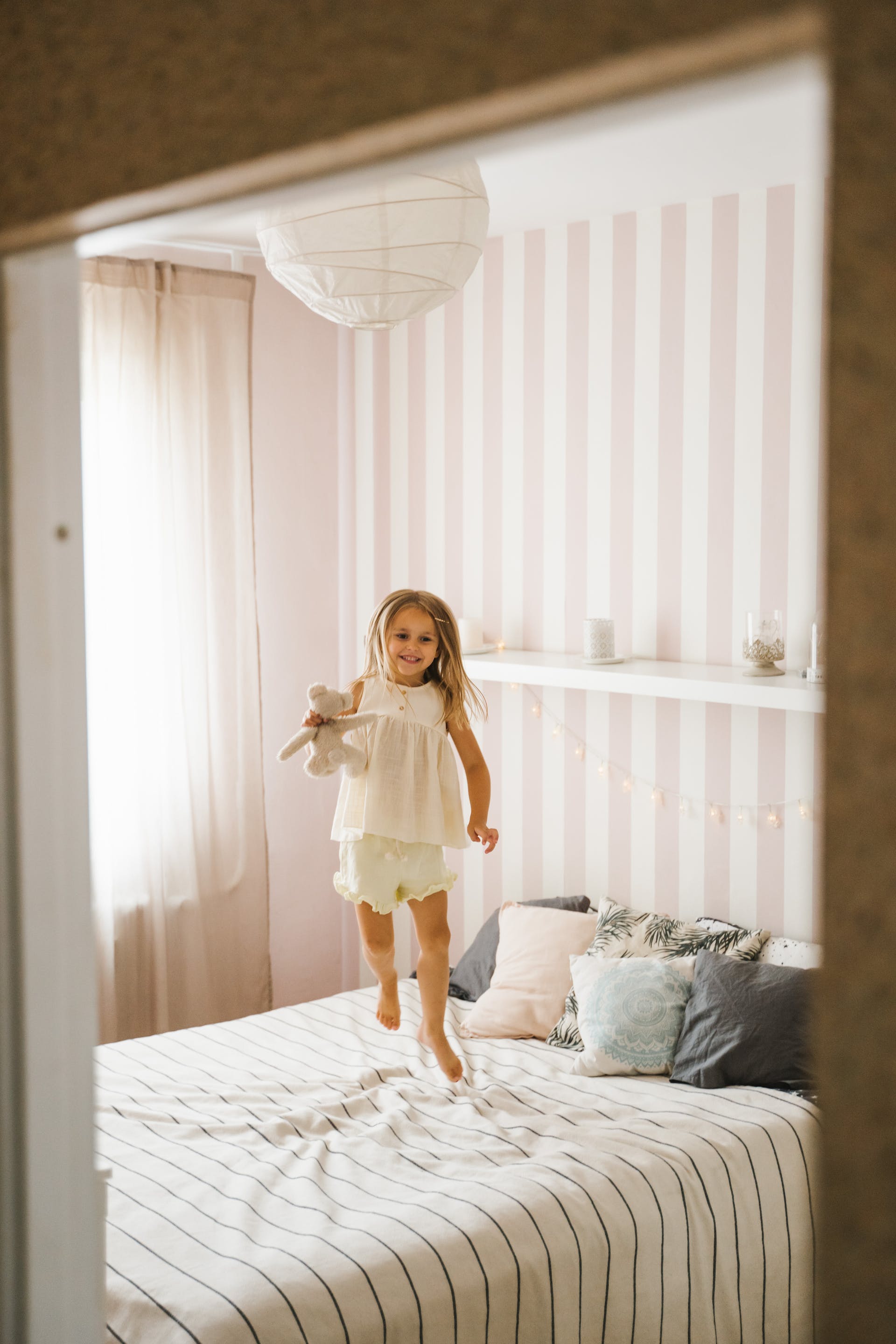 A girl jumping on the bed | Source: Pexels