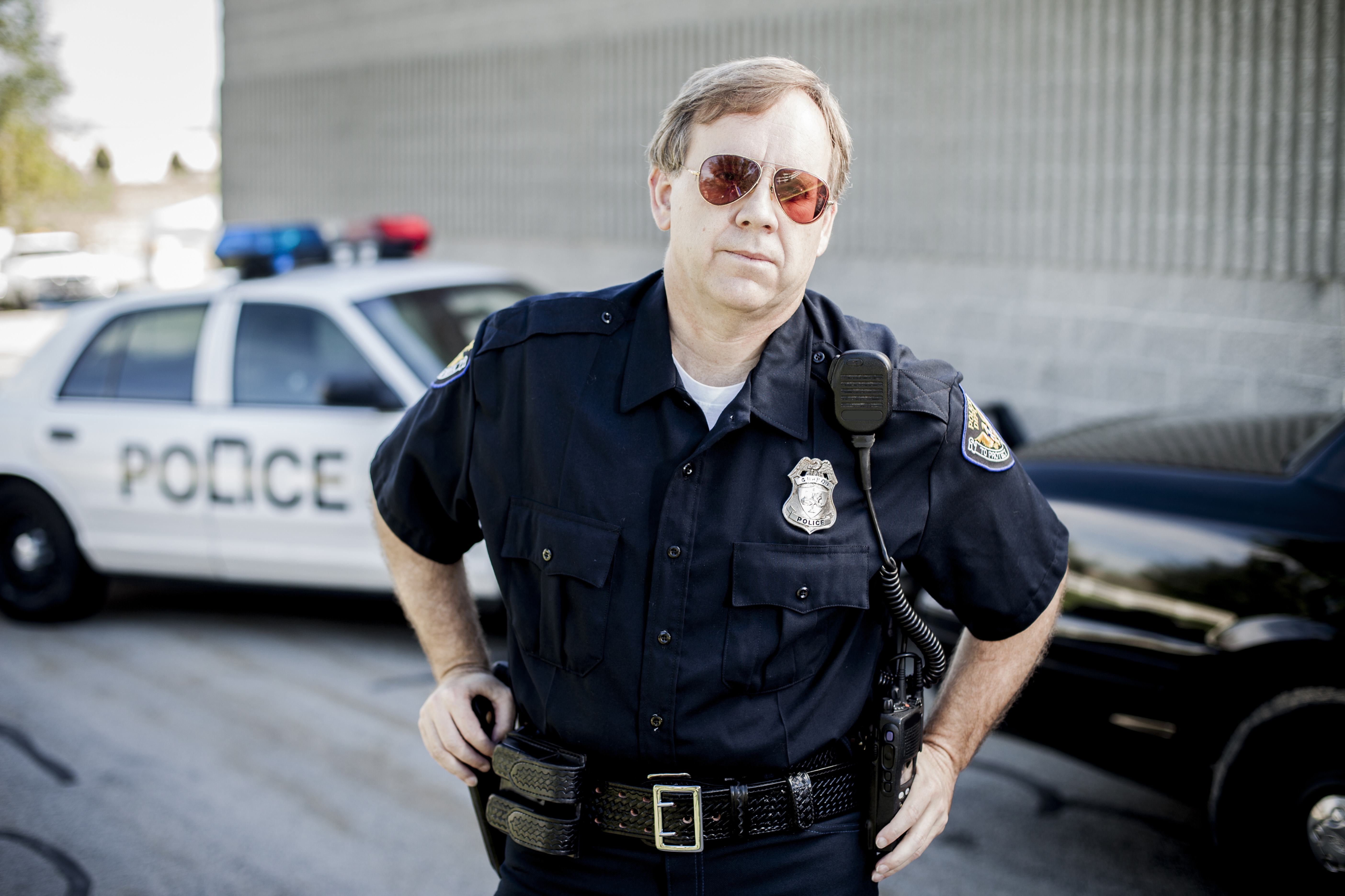 A policeman standing in front of his car | Source: Getty Images