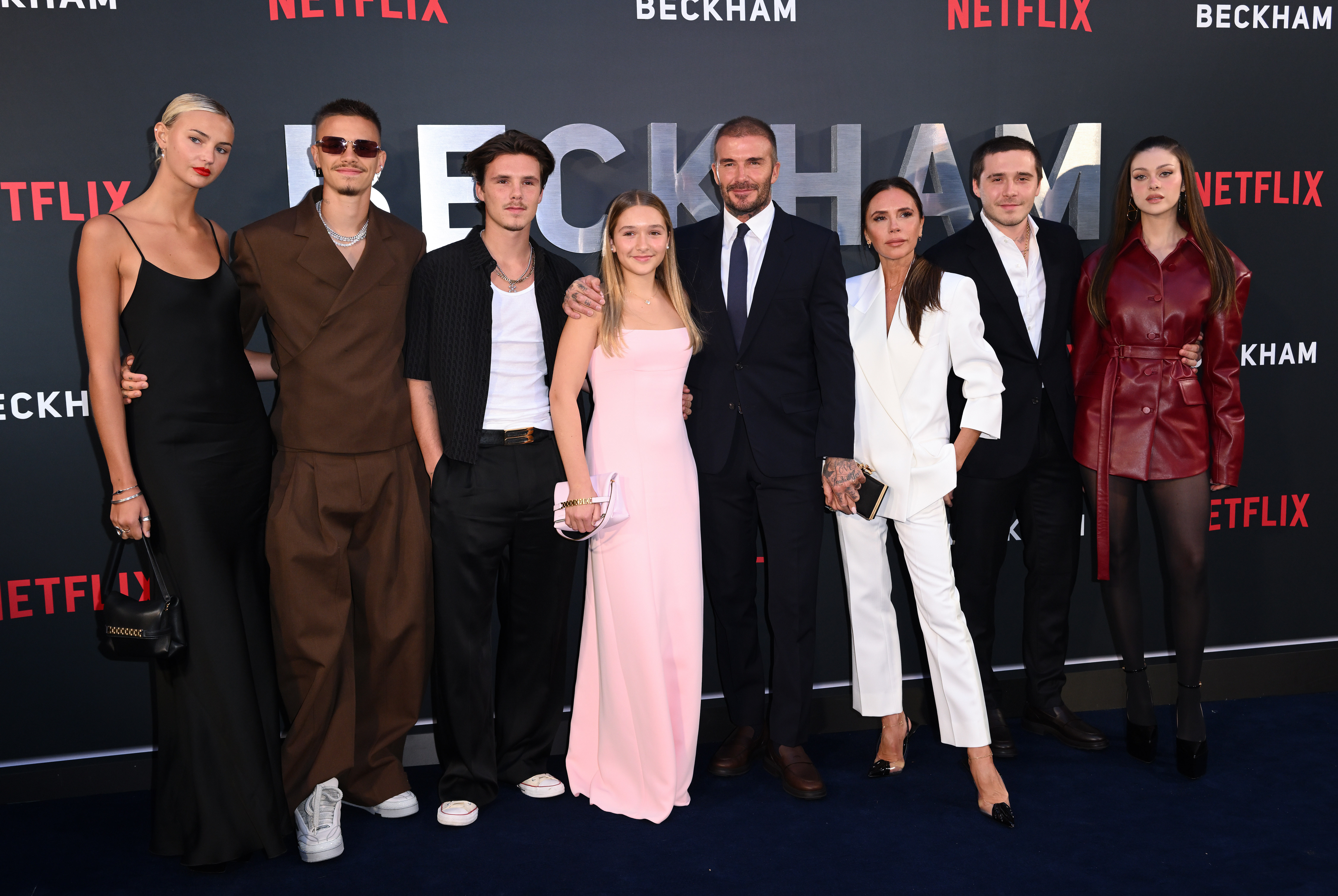 Mia Regan, Romeo Beckham, Cruz Beckham, Harper Beckham, David Beckham, Victoria Beckham, Brooklyn Beckham, and Nicola Peltz attend the premiere of Netflix's "Beckham" in London on October 3, 2023 | Source: Getty Images
