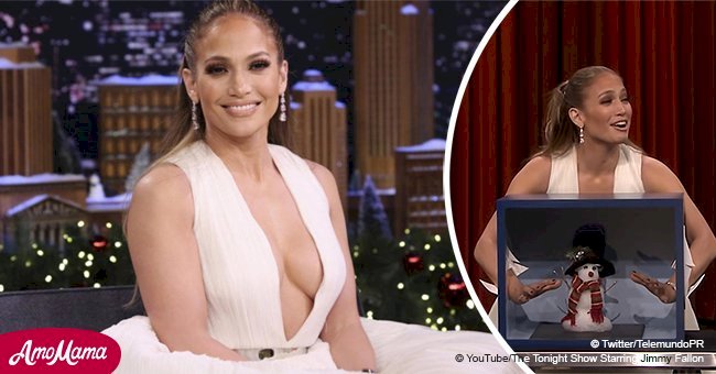 Jennifer Lopez looks like a seductive ballerina, flaunting ample cleavage in a fluffy white dress