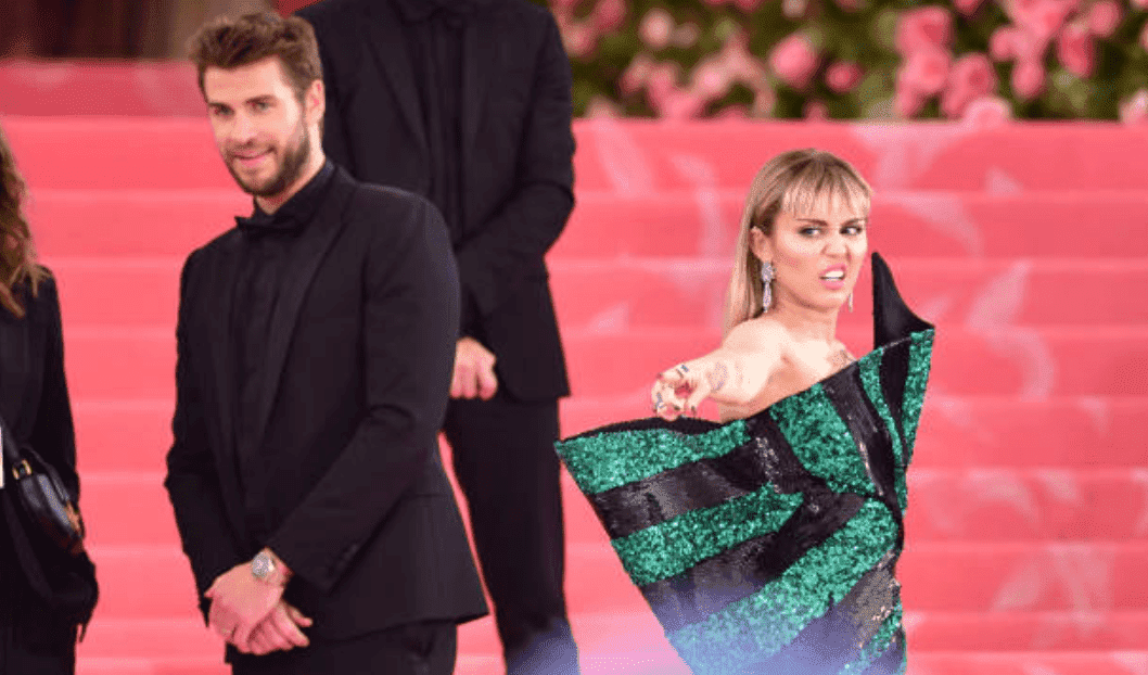 Liam Hemsworth and Miley Cyrus pose on the pink stairs as they arrived at The Met Gala at the Metropolitan Museum of Art, on May 6, 2019, New York City | Source: Getty Images (Photo by James Devaney/GC Images)