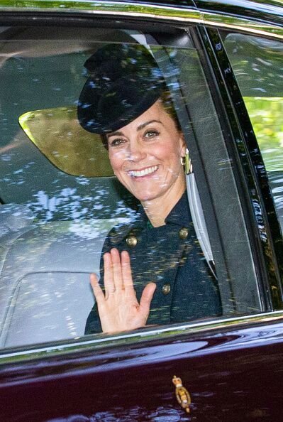 Kate Middleton waves to the crown from inside a car. | Source: Getty Images