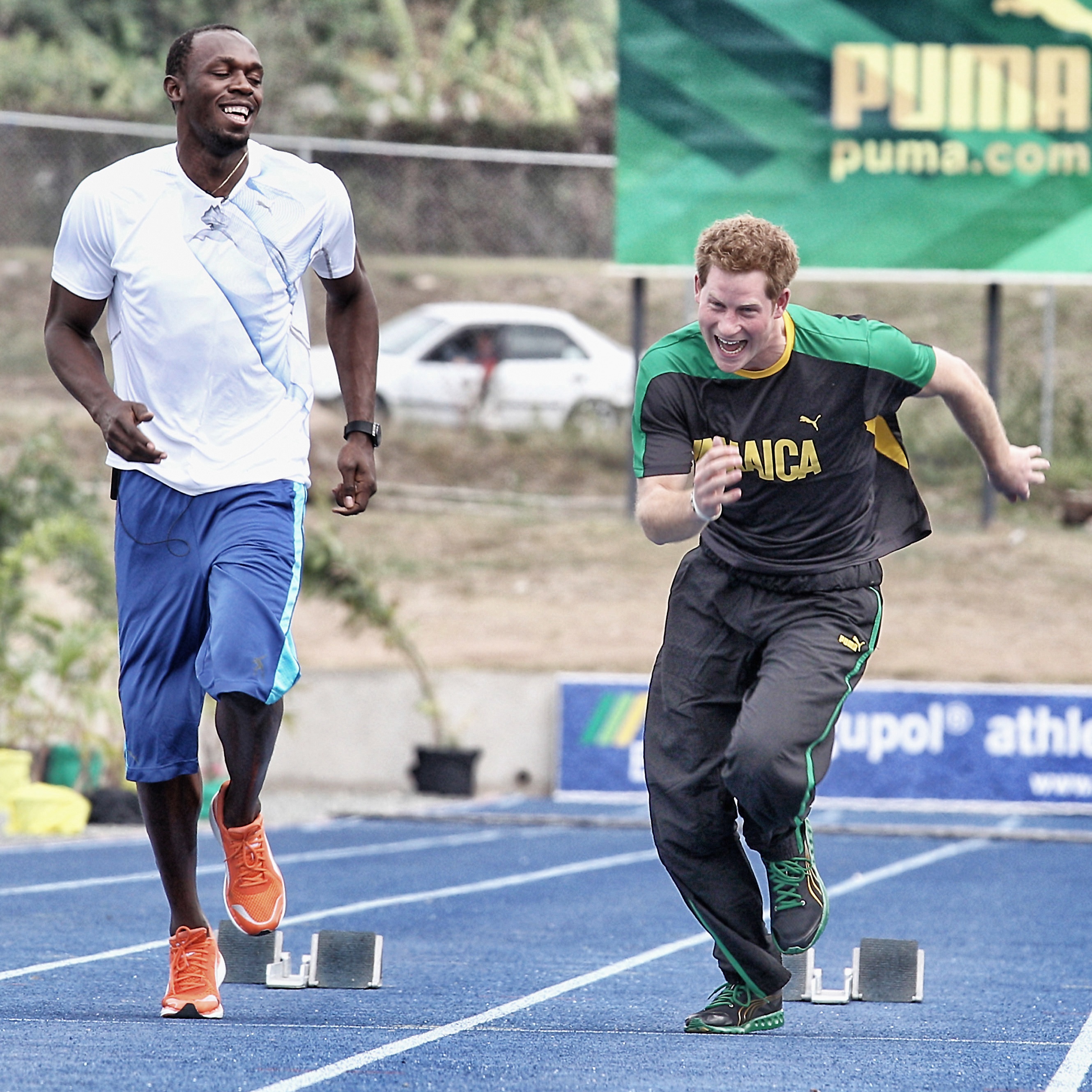 Usain Bolt and Prince Harry racing at the University of the West Indies in Kingston, Jamaica on March 6, 2012 | Source: Getty Images