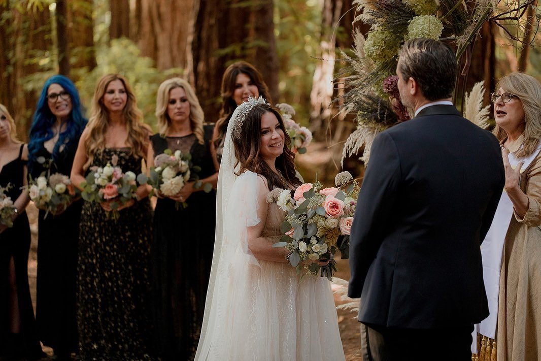 Their ceremony brought together romance, family, and a redwood setting that almost felt made for a "Charmed" alum. This time, however, the magic was not scripted. | Source: Instagram/thehmc
