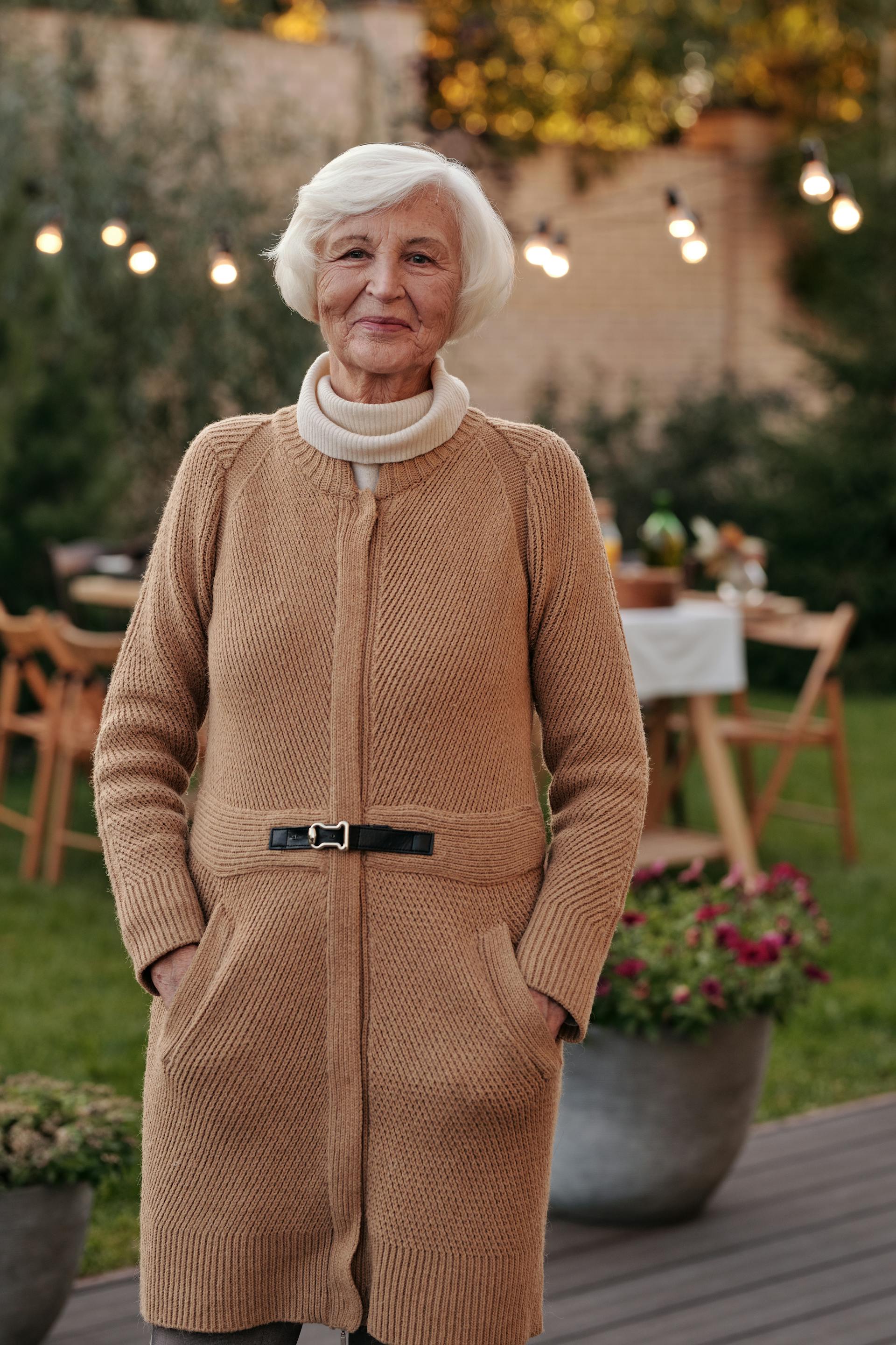 A smiling old woman wearing a coat | Source: Pexels