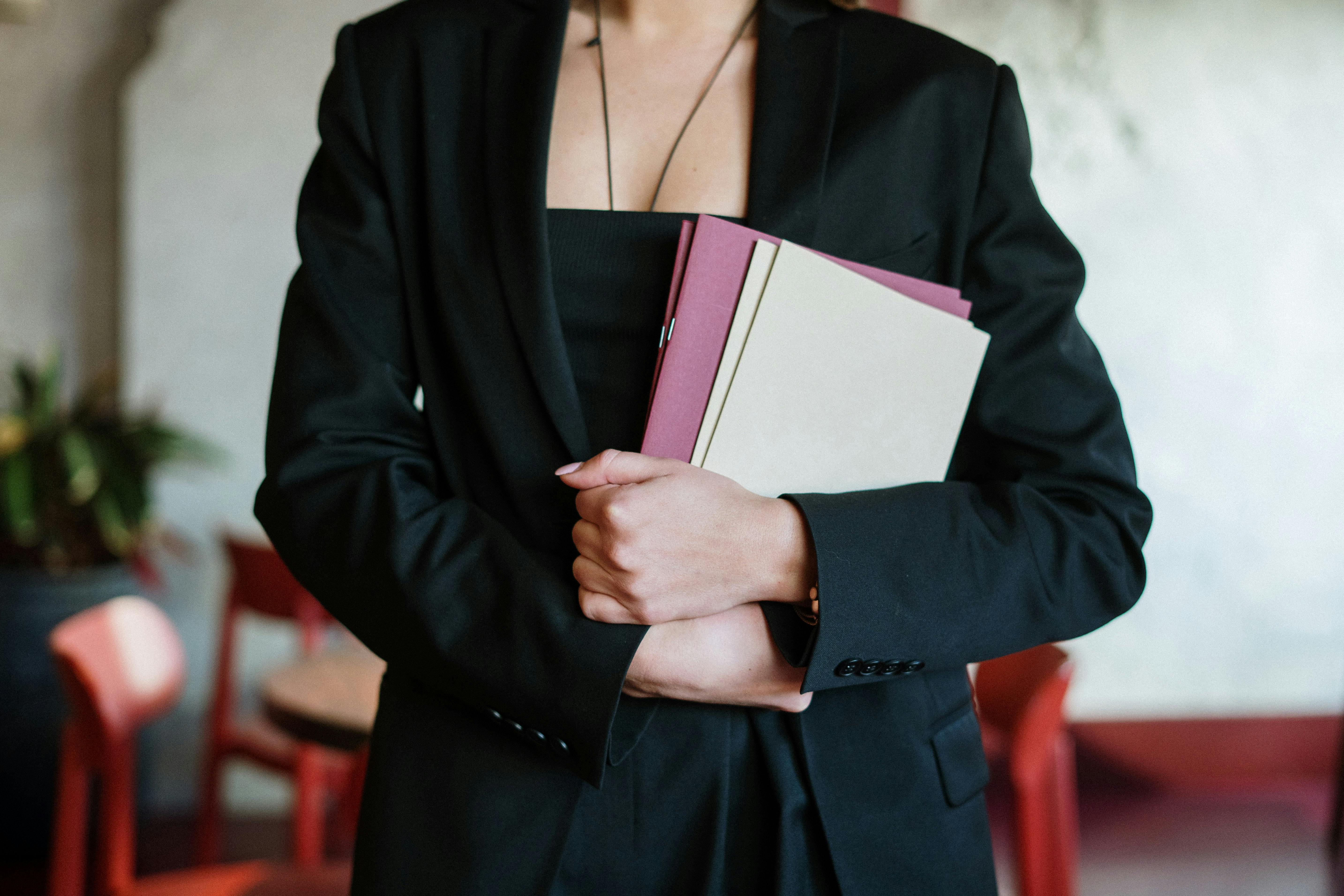 A restaurant hostess holding the restaurant booking sheets | Source: Pexels