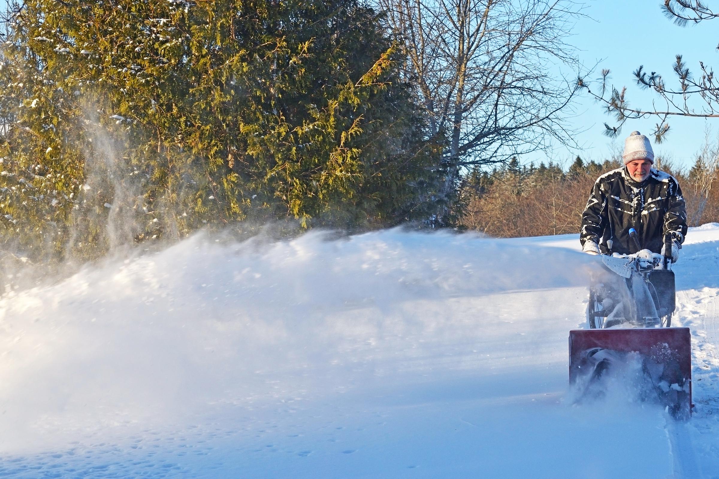 Senior man snowblowing | Source: Shutterstock
