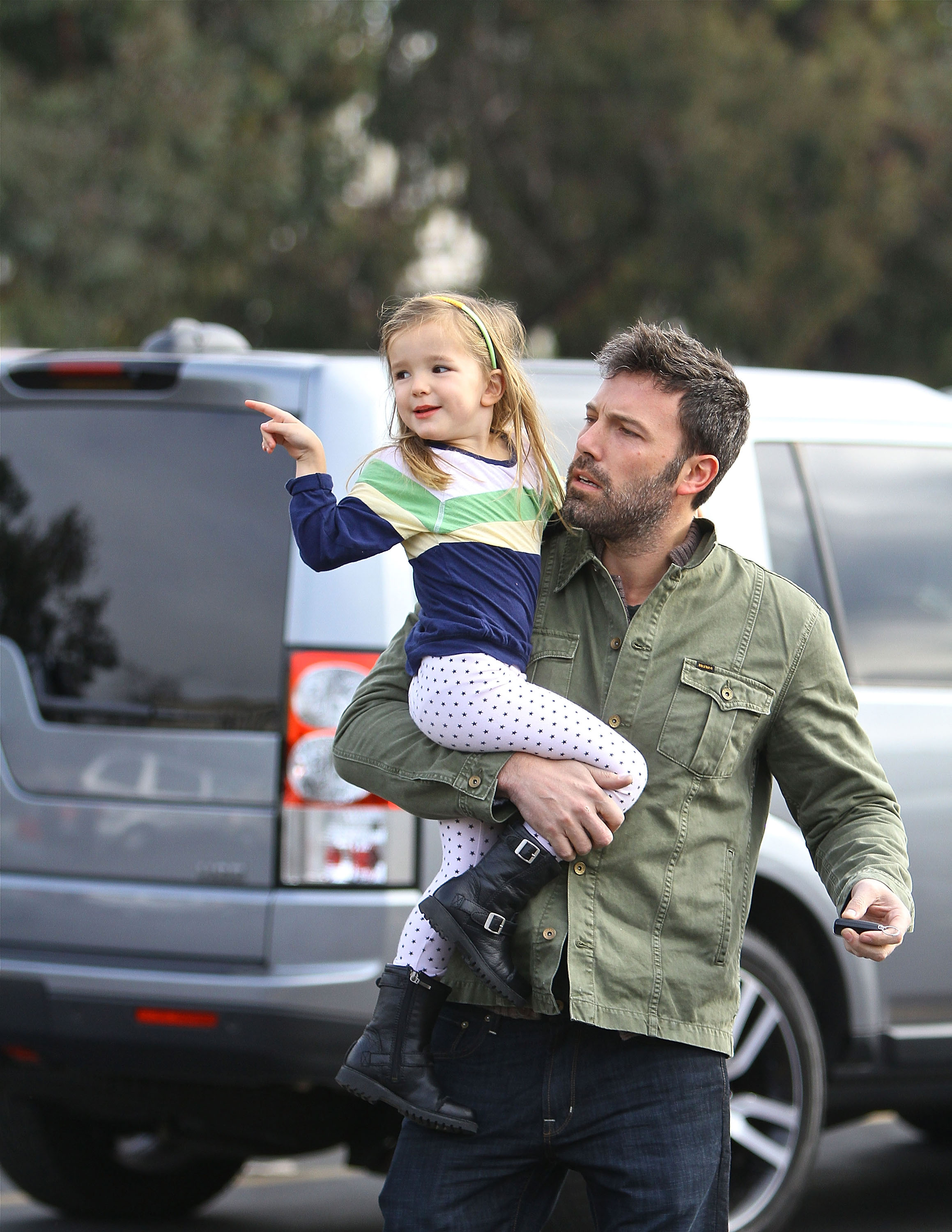 Ben Affleck carries a young Seraphina Affleck — now known as Fin —while out in Brentwood, California, on December 23, 2012. The image offers an early glimpse of the father and child years before their recent public outings together. | Source: Getty Images