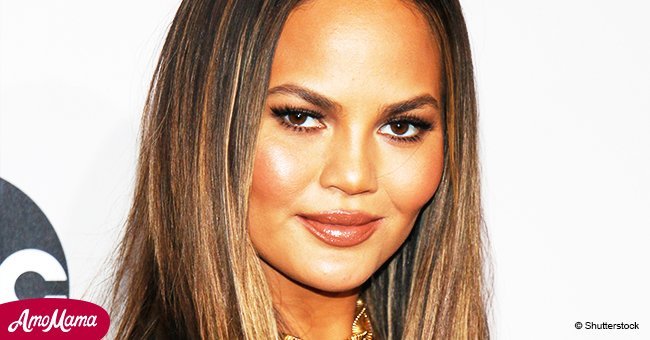 Chrissy Teigen, 32, showcases her huge baby bump as she wears a very see-through black top