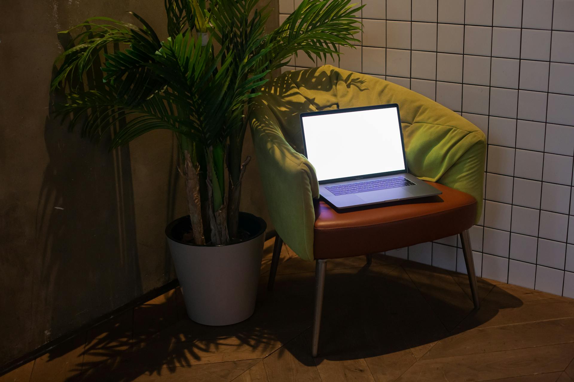 An open laptop on a chair | Source: Pexels