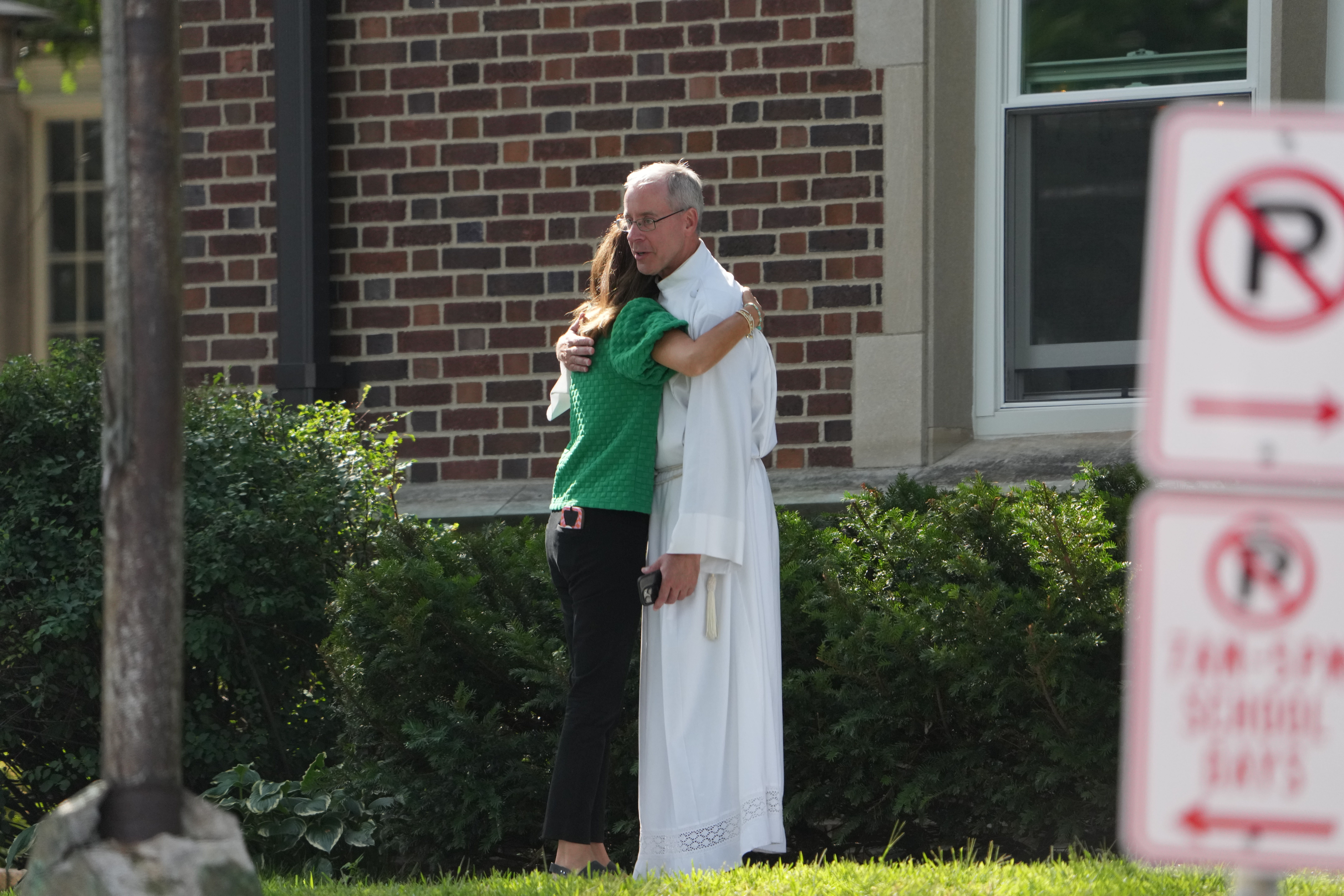 Members of the church comforting one another after a shooting at Annunciation Catholic Church on August 27, 2025, in Minneapolis, Minnesota. | Source: Getty Images