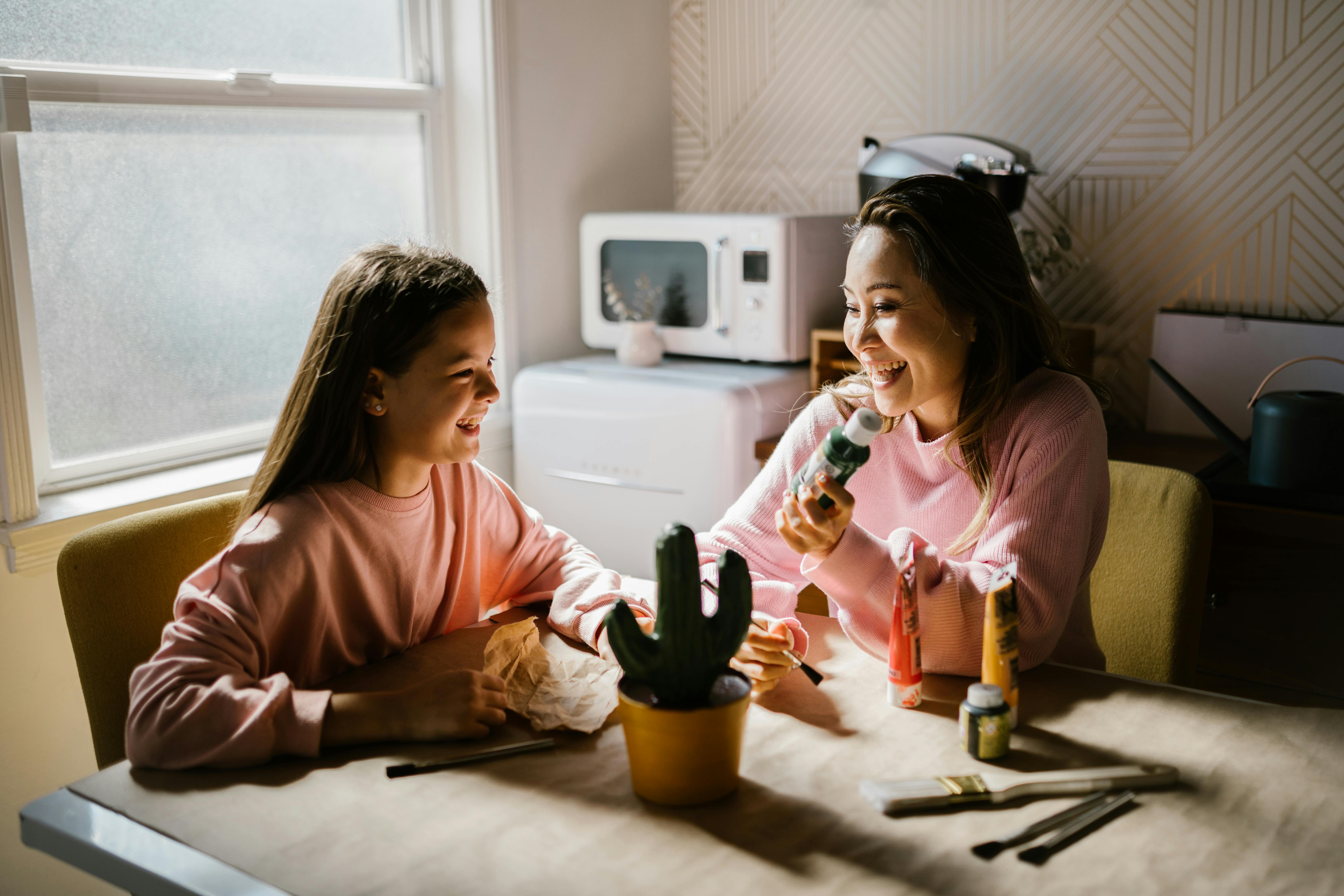 A woman and a girl working on a craft project | Source: Pexels