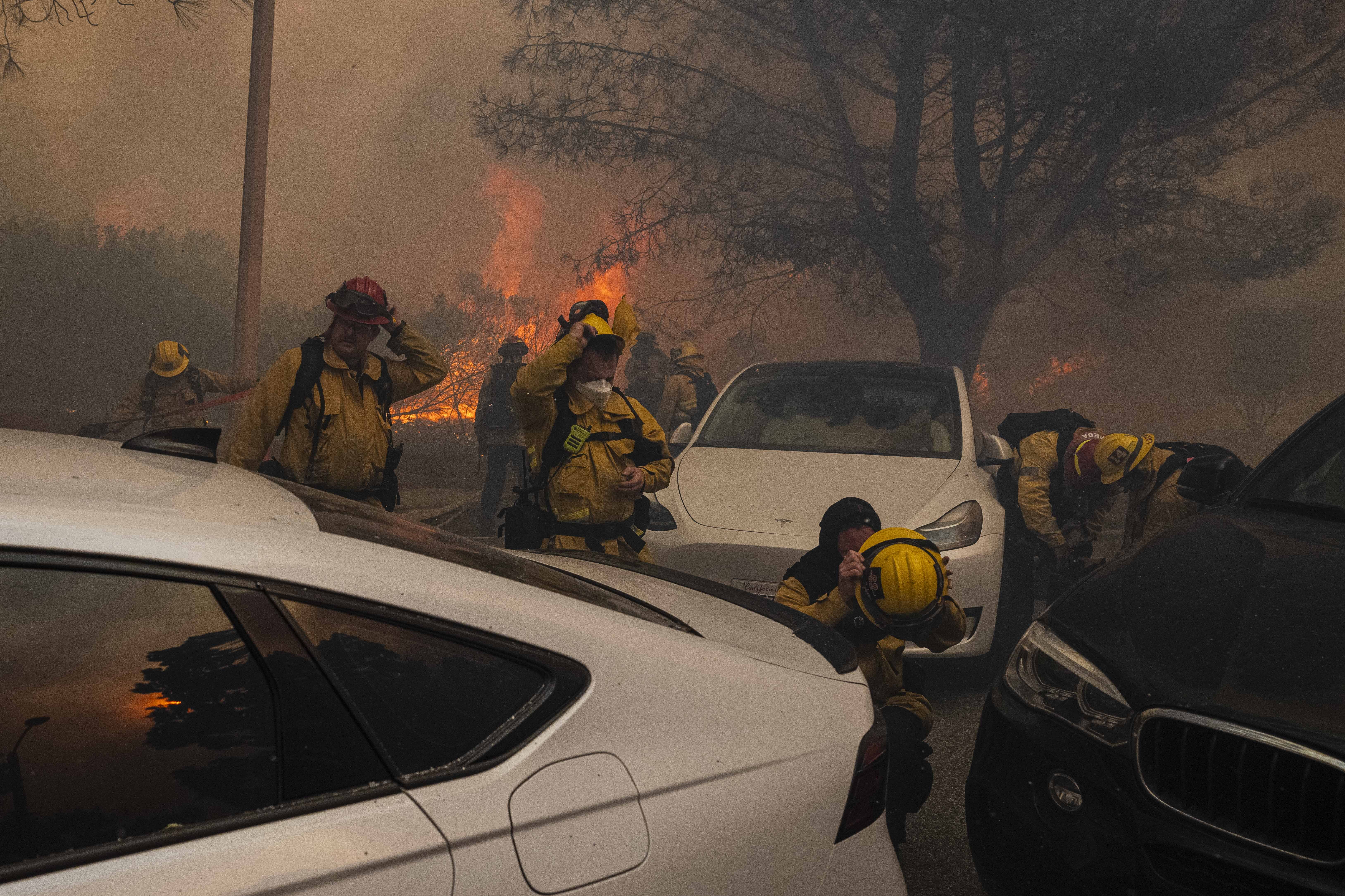 Firefighters gearing up to combat flames from a wildfire in Pacific Palisades, California on January 8, 2025. | Source: Getty Images