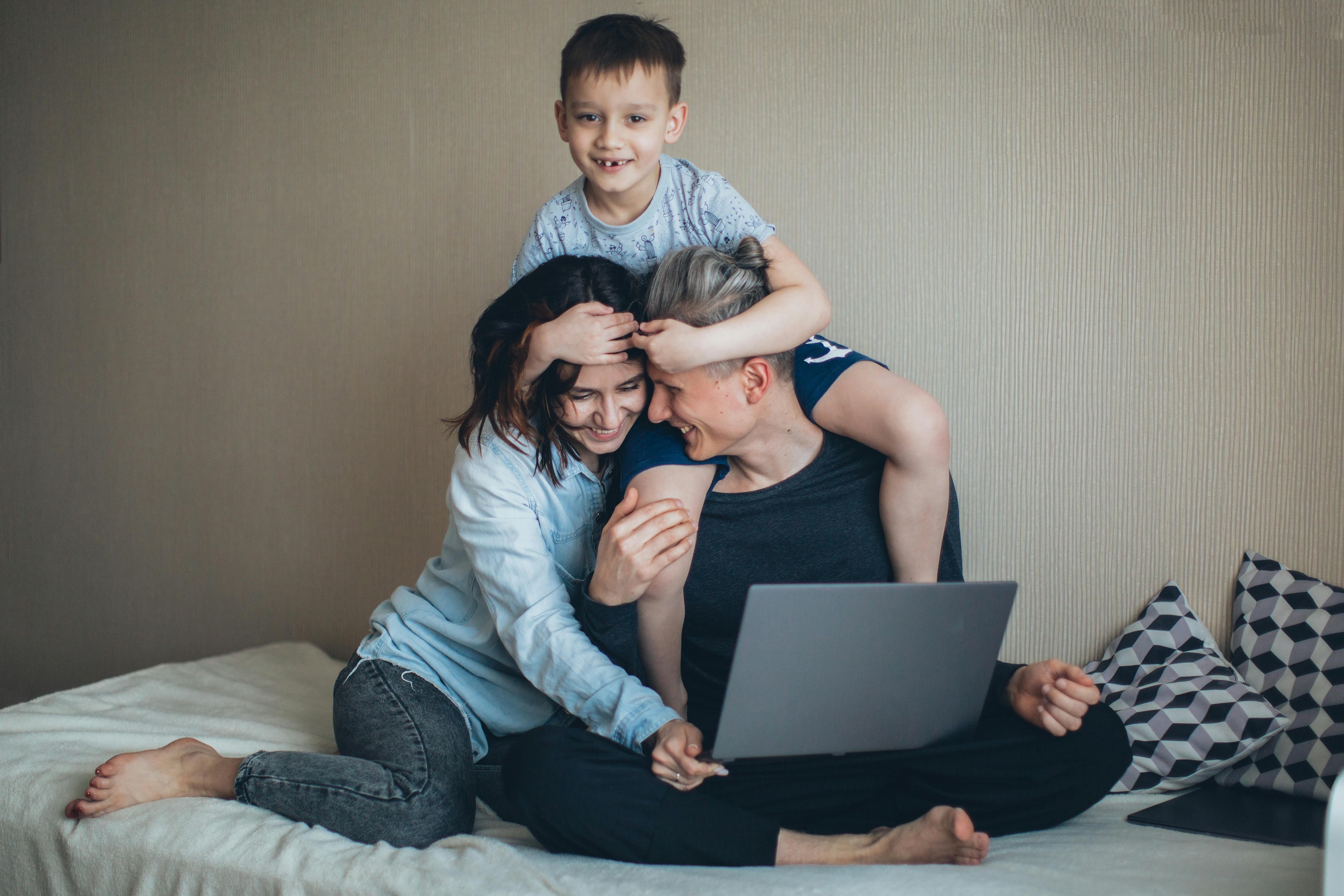 A boy embracing his parents | Source: Pexels