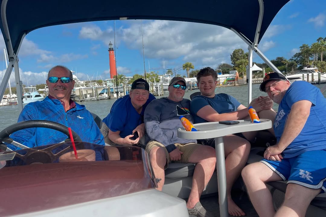 Alex Miller and several friends, including Mark Laws, during a boat trip, from a tribute post, dated May 27, 2025 | Source: Instagram/amillermusic