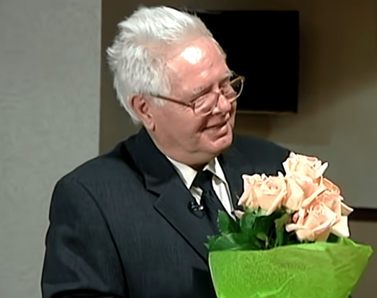 Clifford Boyson holding pink roses. │Source: youtube.com/ABC News