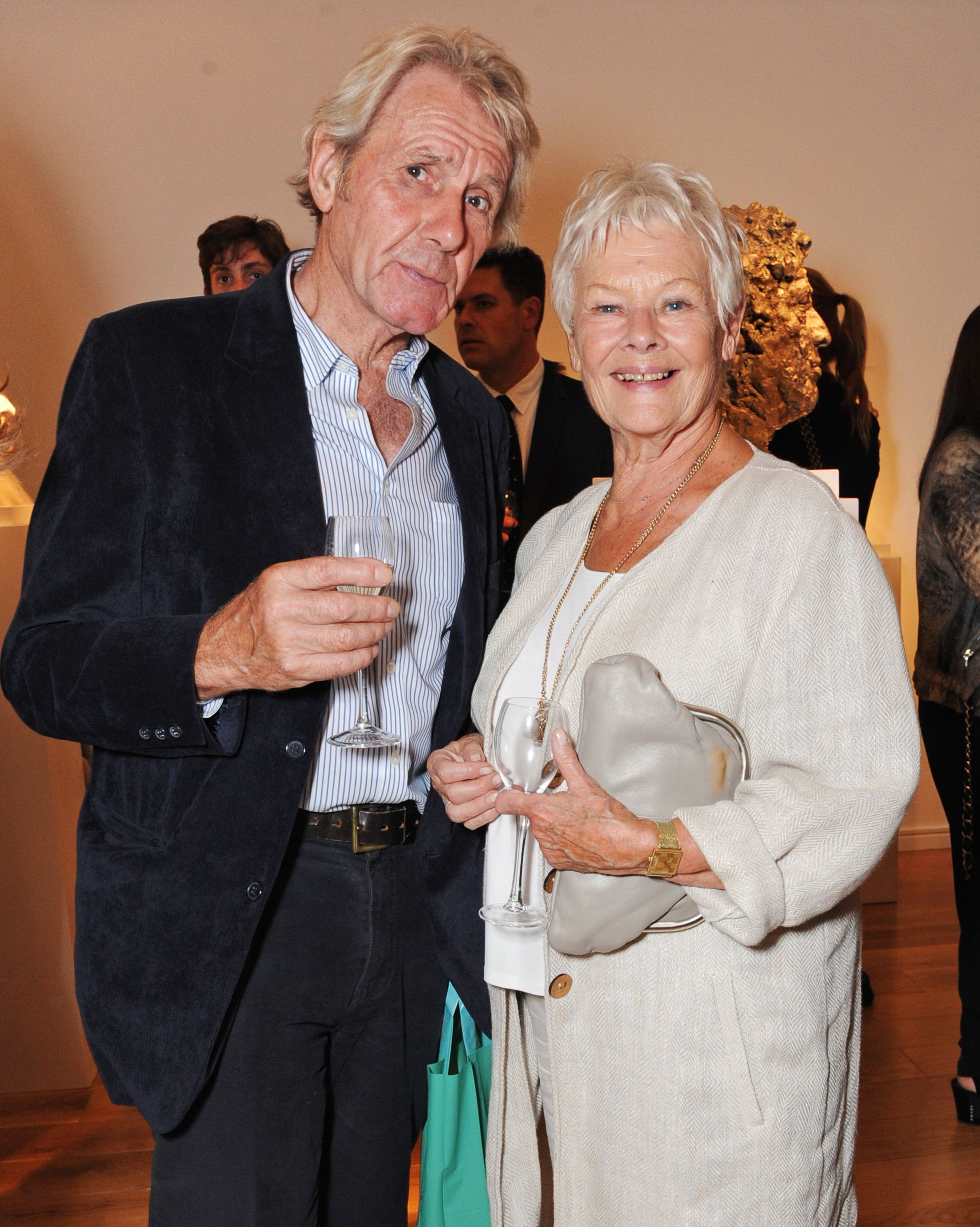 Dame Judi Dench and David Mills at Nicole Farhi's debut exhibition "From The Neck Up" in 2014 in London, England | Source: Getty Images 