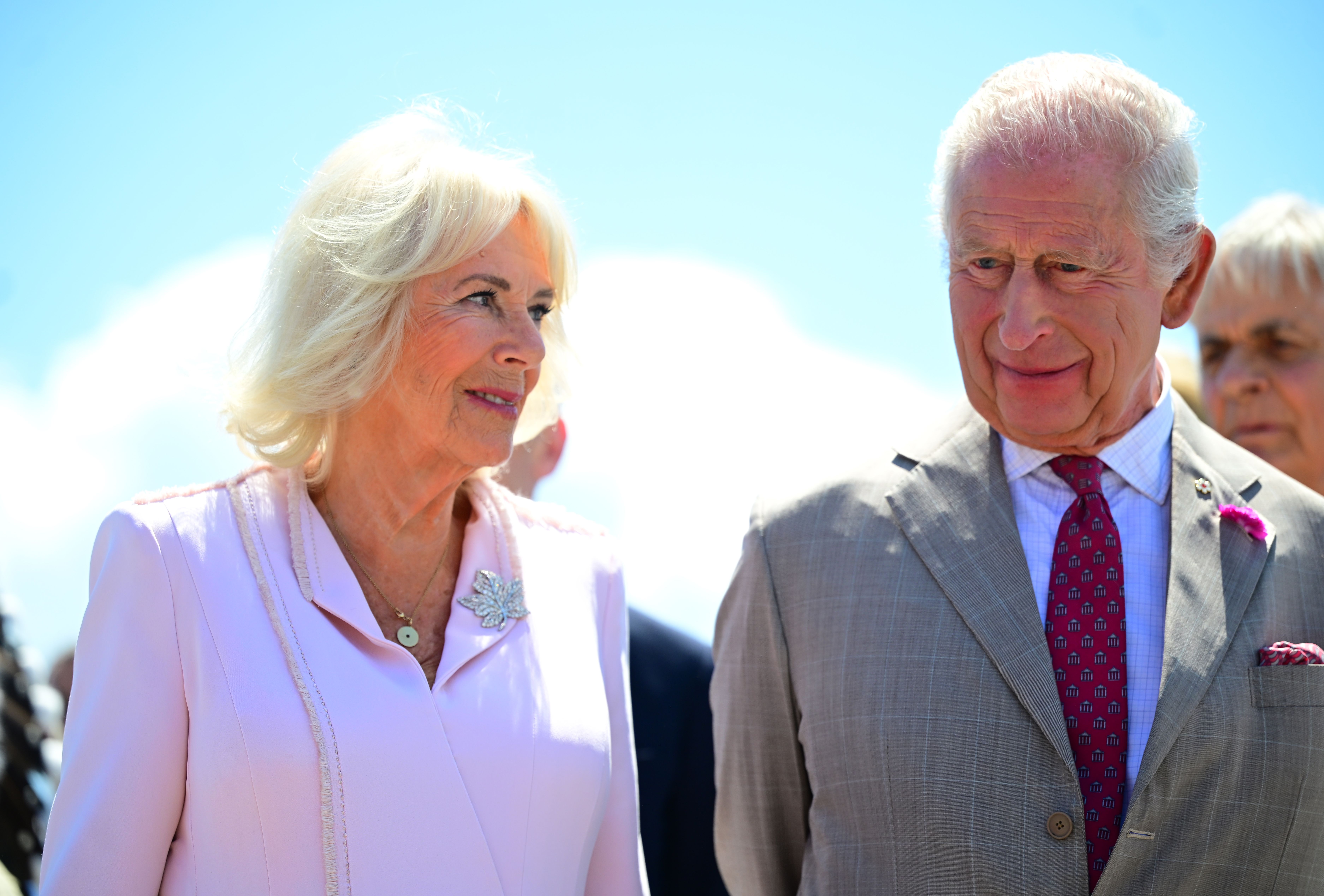 Amid the flurry of official activity, a candid shot captures King Charles III and Queen Camilla sharing a quiet, personal moment in conversation.