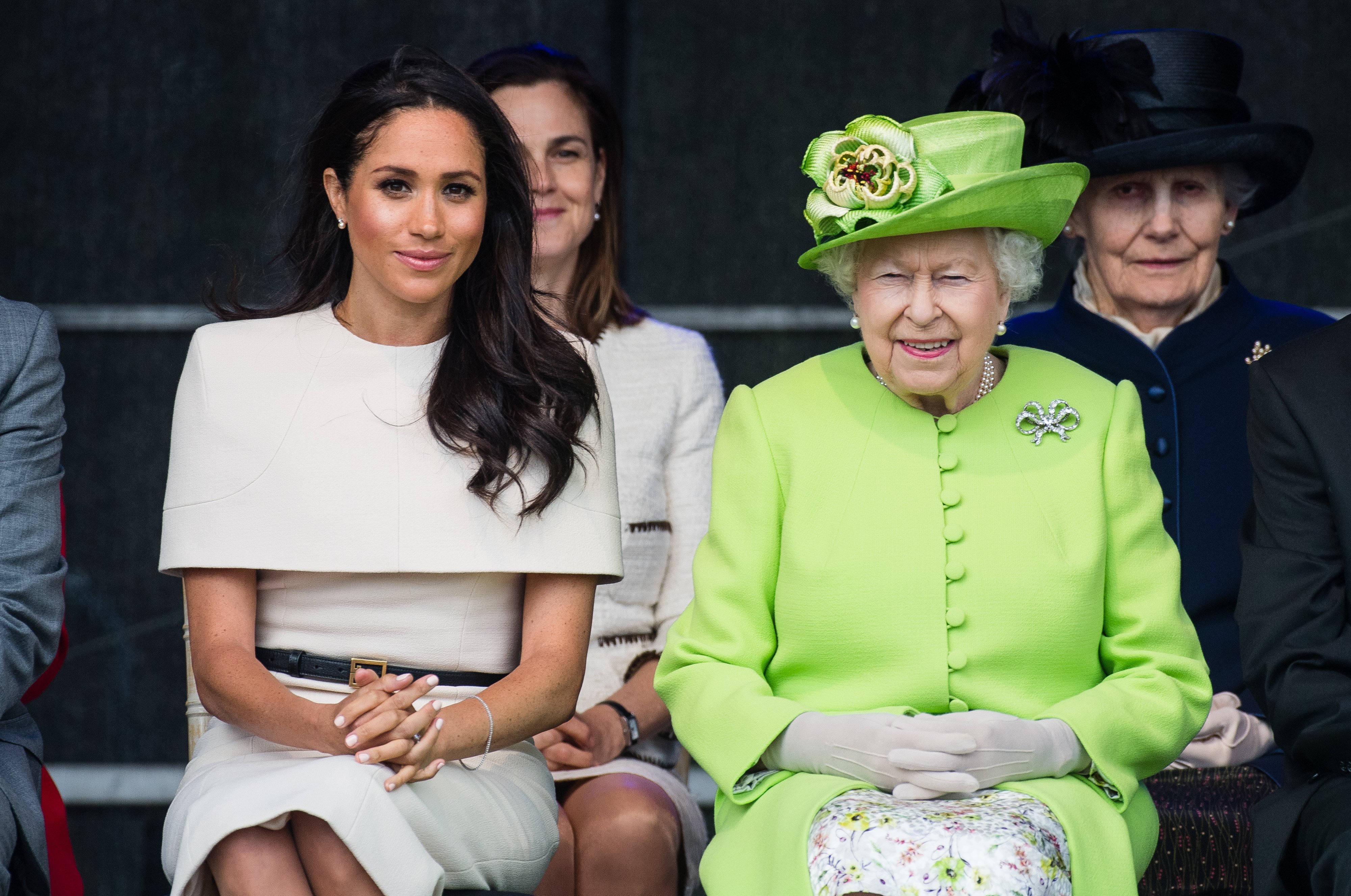 Meghan Markle, Duchess of Sussex, sits with Queen Elizabeth II at a ceremony to open the new Mersey Gateway Bridge on June 14, 2018, in Halton, Cheshire, England. | Source: Getty Images