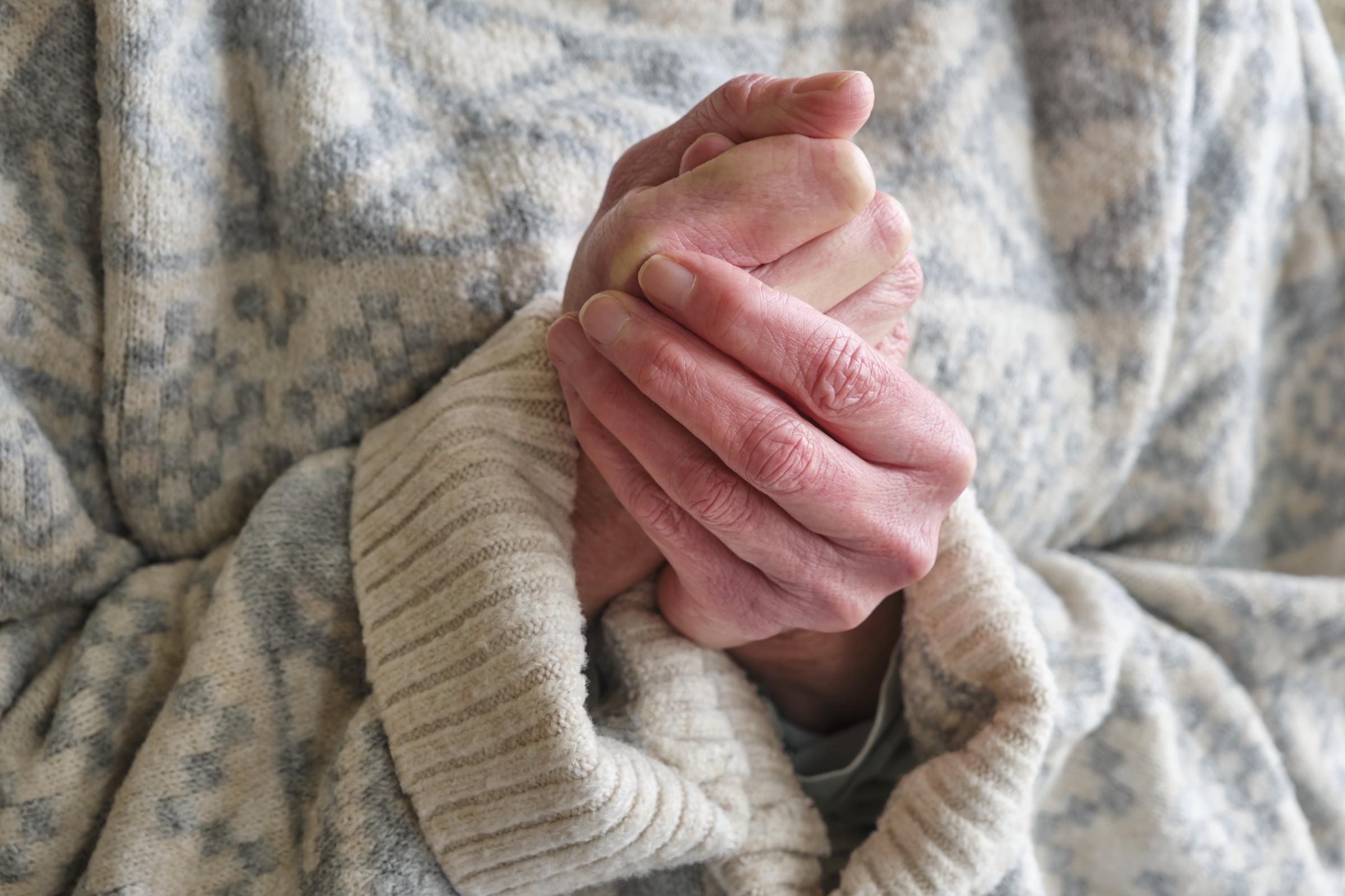A woman trying to warm her hands | Source: Getty Images