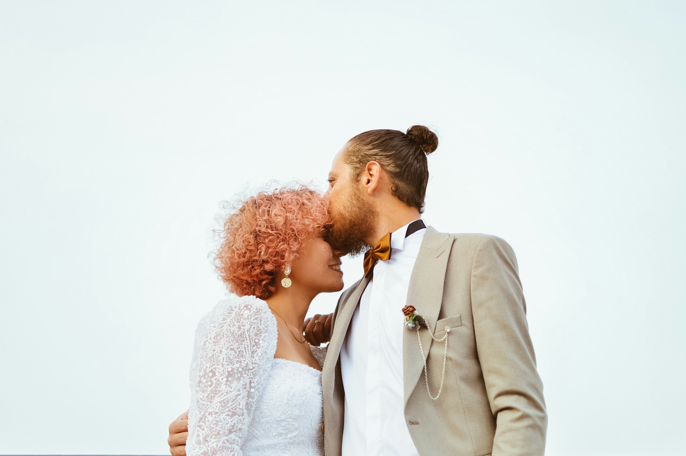 Bride and groom being affectionate | Source: Unsplash