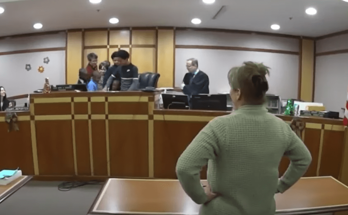 A proud mother watches as the adoption of her six children becomes official |  Photo: Youtube / WISN 12 News
