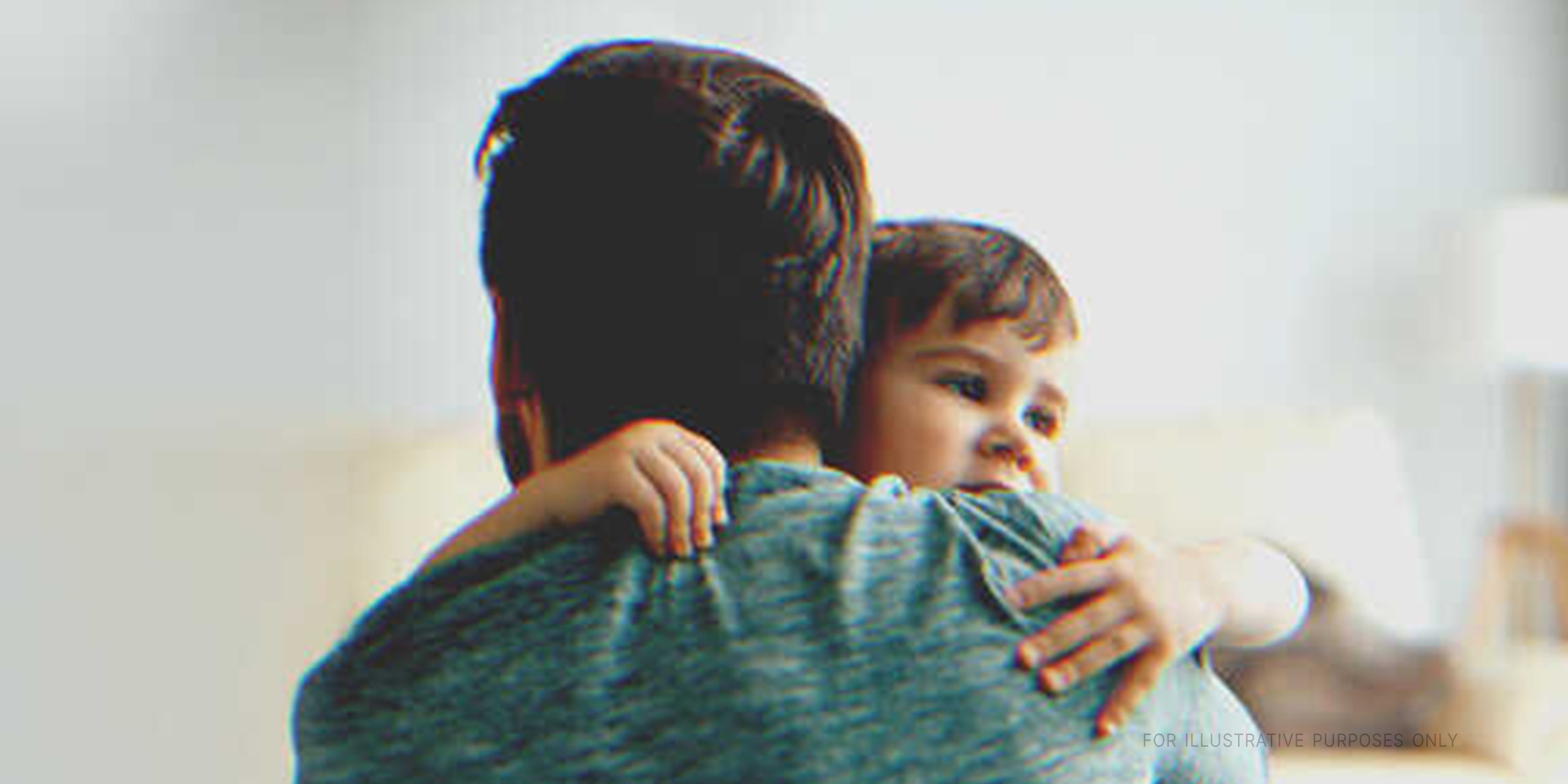 Man hugging a little boy | Source: Shutterstock