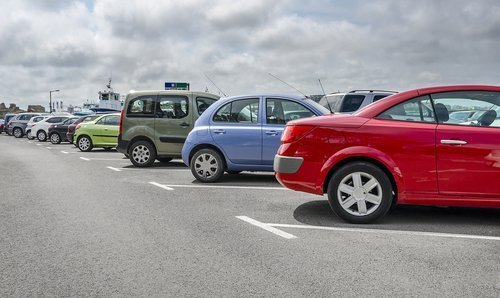 Cars parked in parking lot. | Source: Shutterstock.