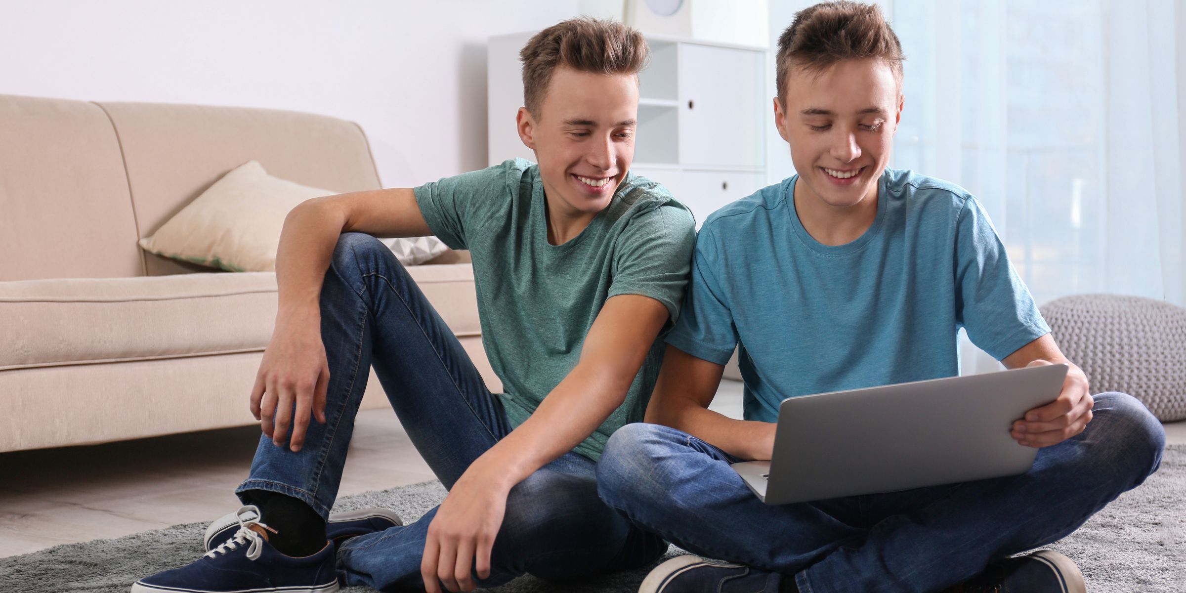 Twin boys using a laptop | Source: Shutterstock