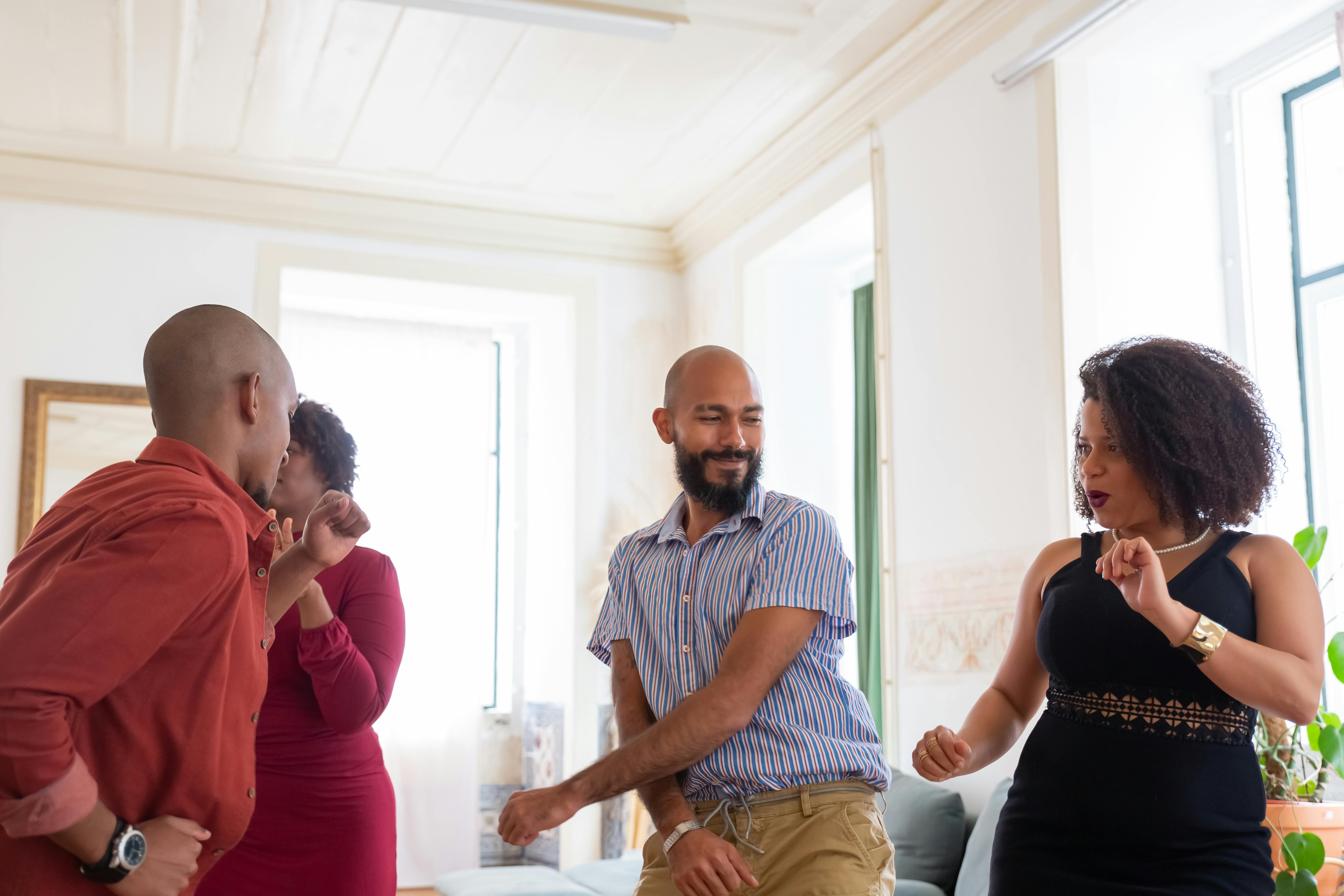 A group of friends dancing in the living room | Source: Pexels