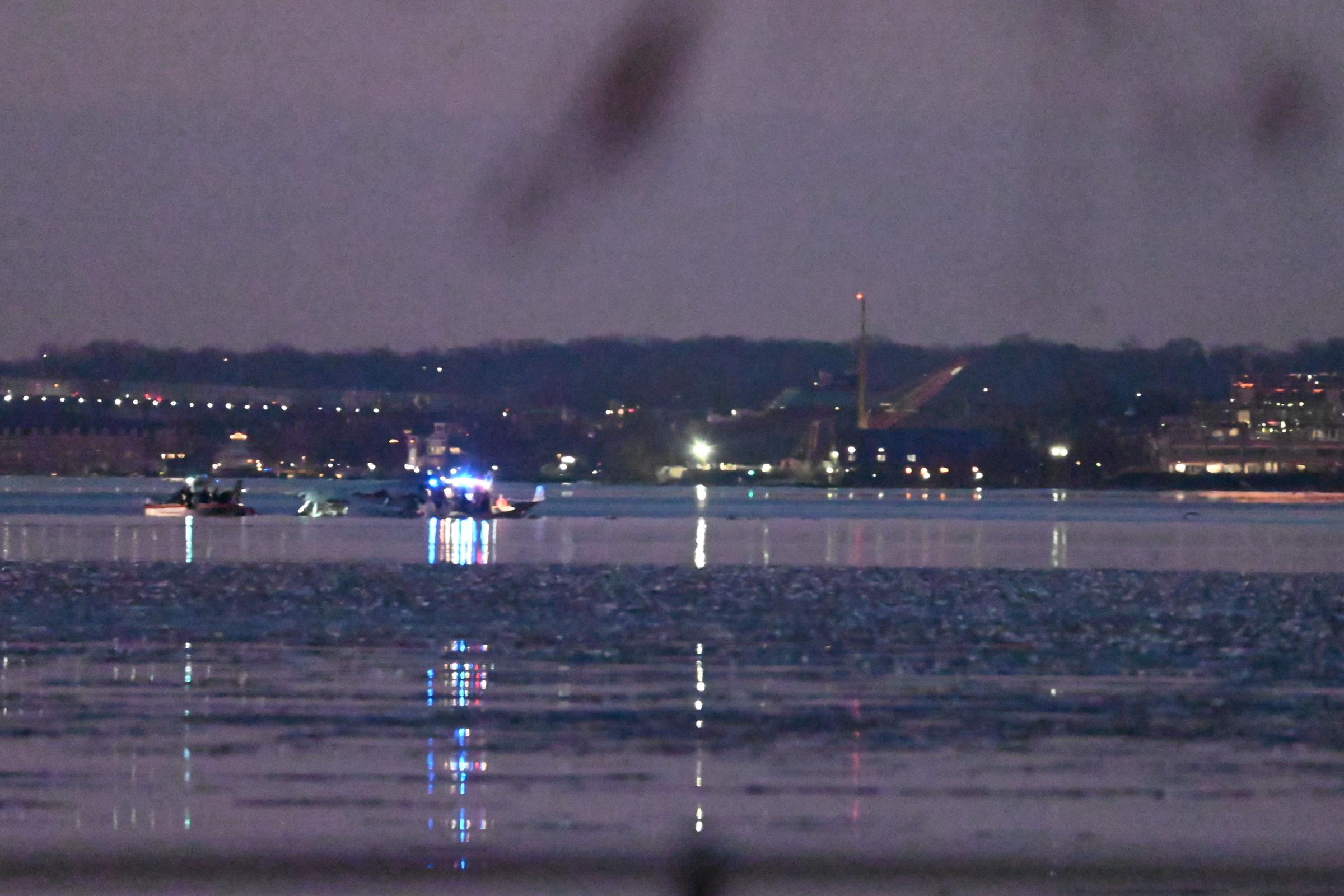 A view of the scene cordon and wreckage in daylight after a regional plane collided in midair with a military helicopter and crashed into the Potomac River in Washington D.C. on January 30, 2025 | Source: Getty Images