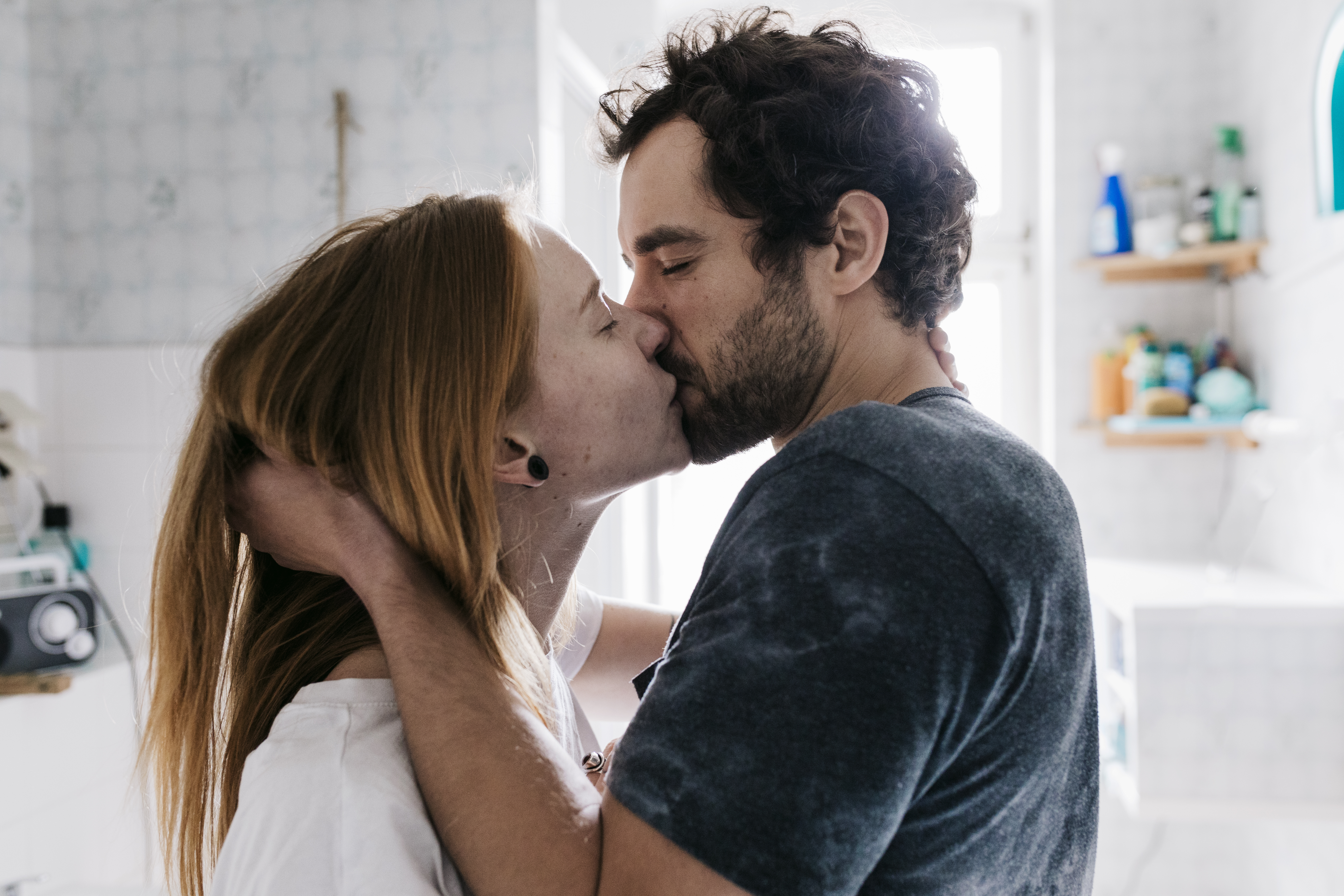 Ein Mann packt den Hinterkopf und die Haare einer Frau, während sie sich mit geschlossenen Augen leidenschaftlich küssen | Quelle: Getty Images