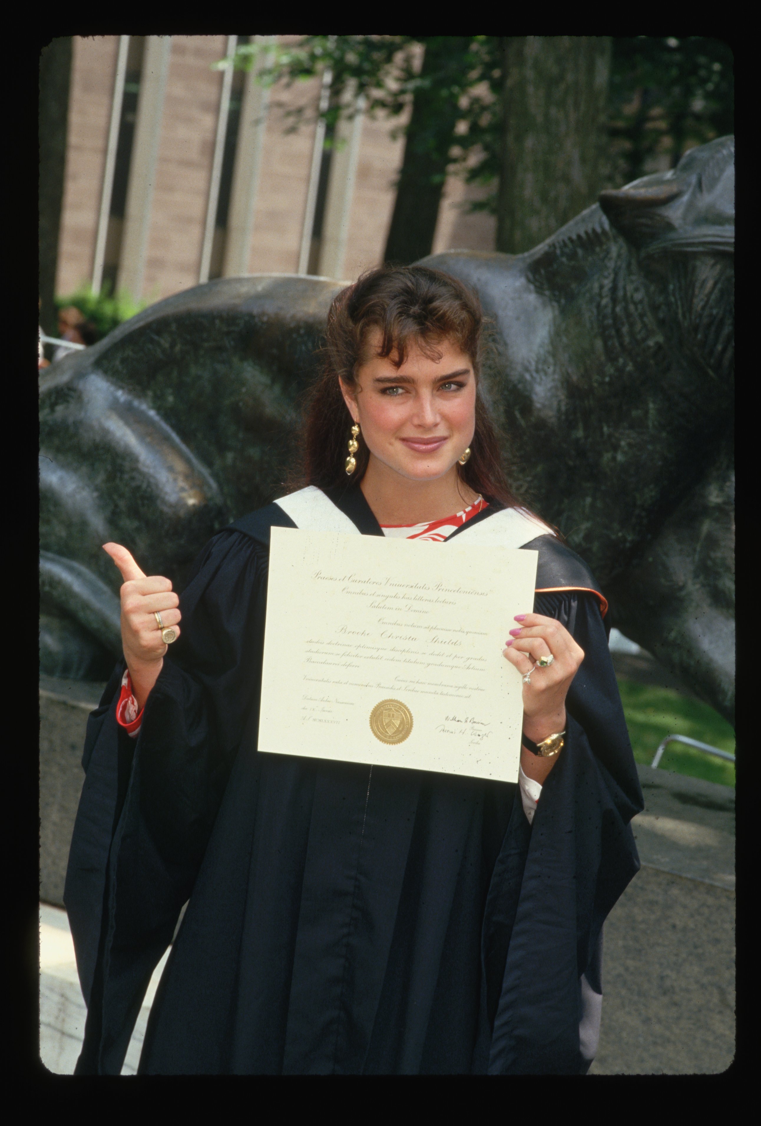 Brooke Shields posing while holding her diploma from Princeton University on her graduation day. / Source: Getty Images