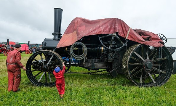 A grandfather and his grandson pictured having fun on a field | Photo: Getty Images