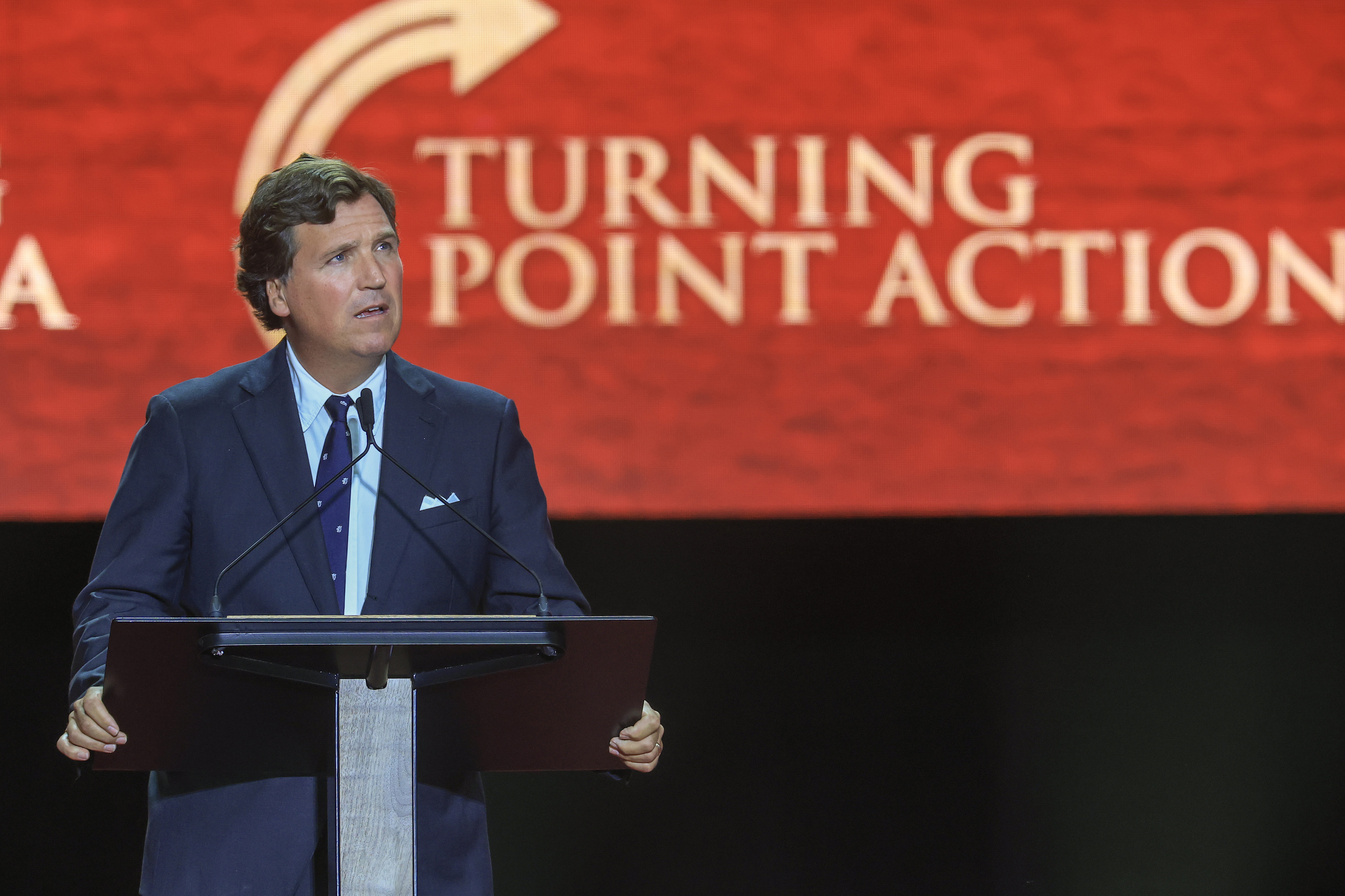 Political commentator Tucker Carlson speaks during the memorial service on September 21, 2025 | Source: Getty Images
